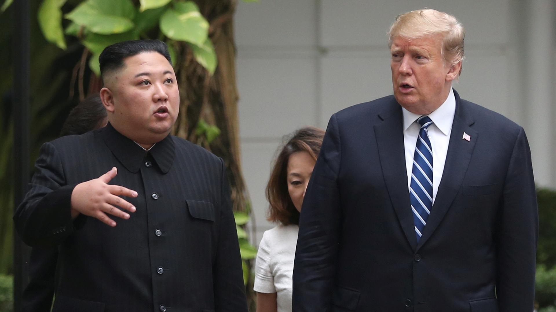 North Korea's leader Kim Jong-un and US President Donald Trump stand side by side in the garden