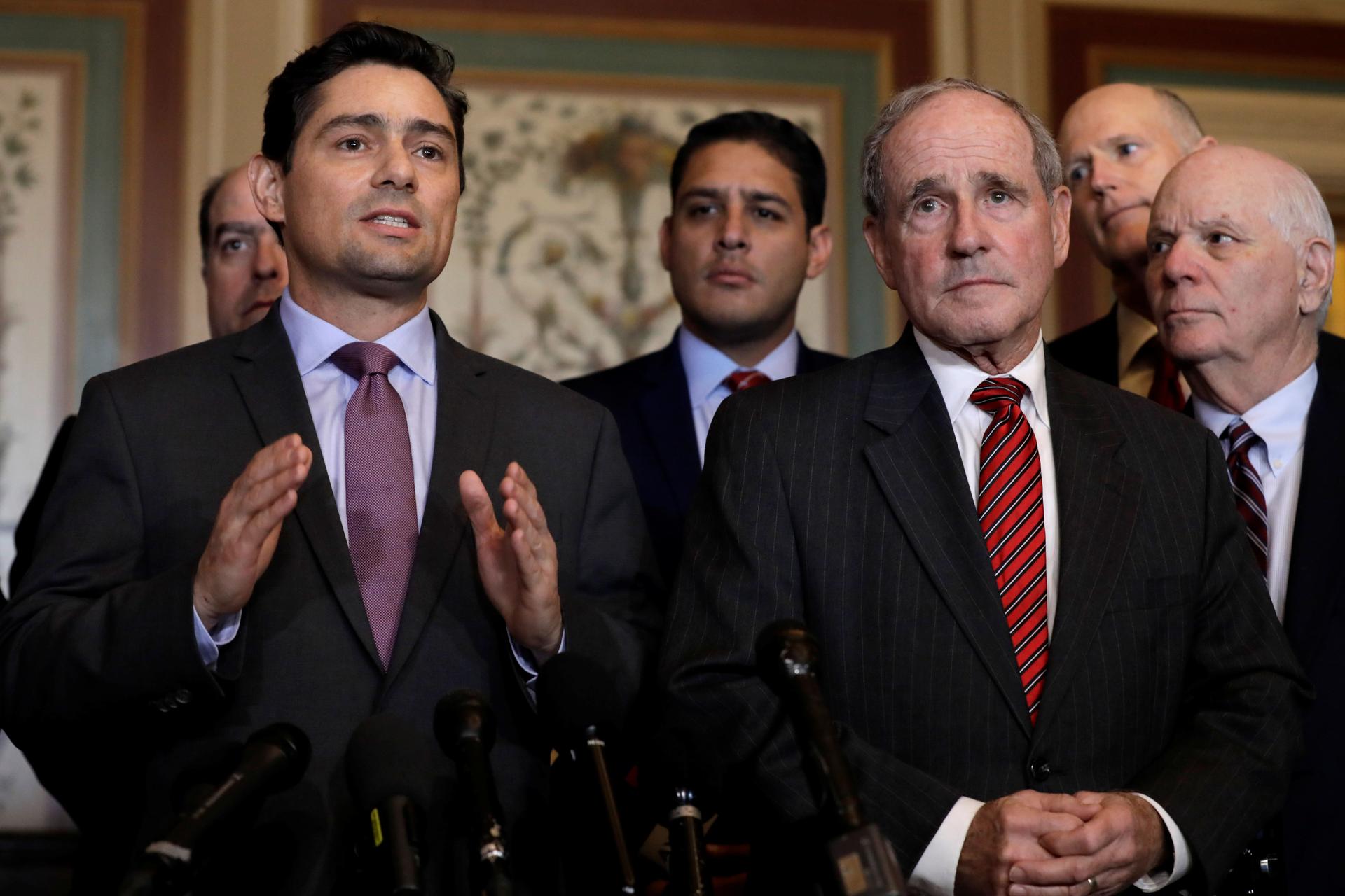 Carlos Alfredo Vecchio gestures while standing next to Senator Jim Risch