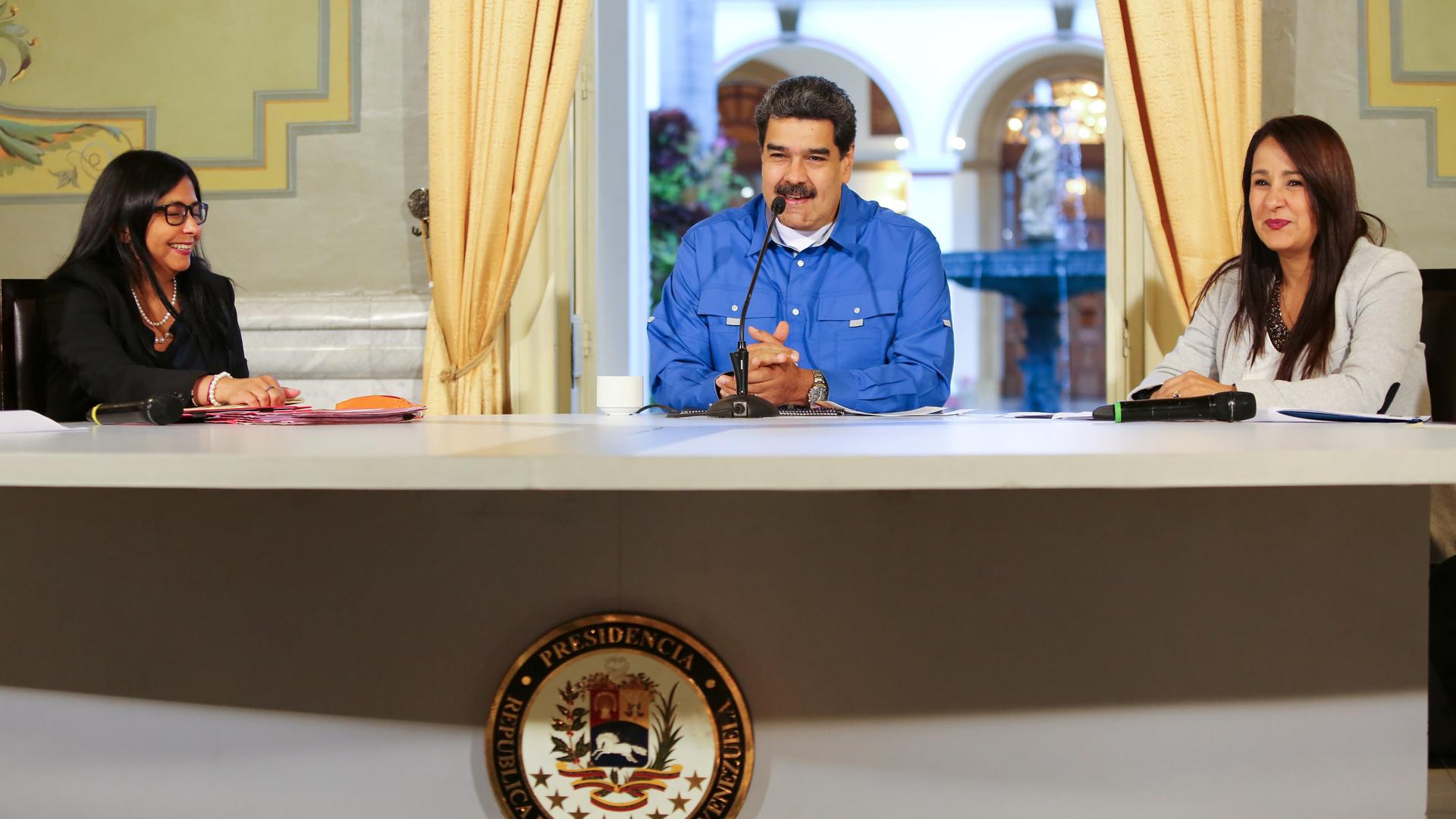 Venezuela's President Nicolás Maduro speaks behind a table