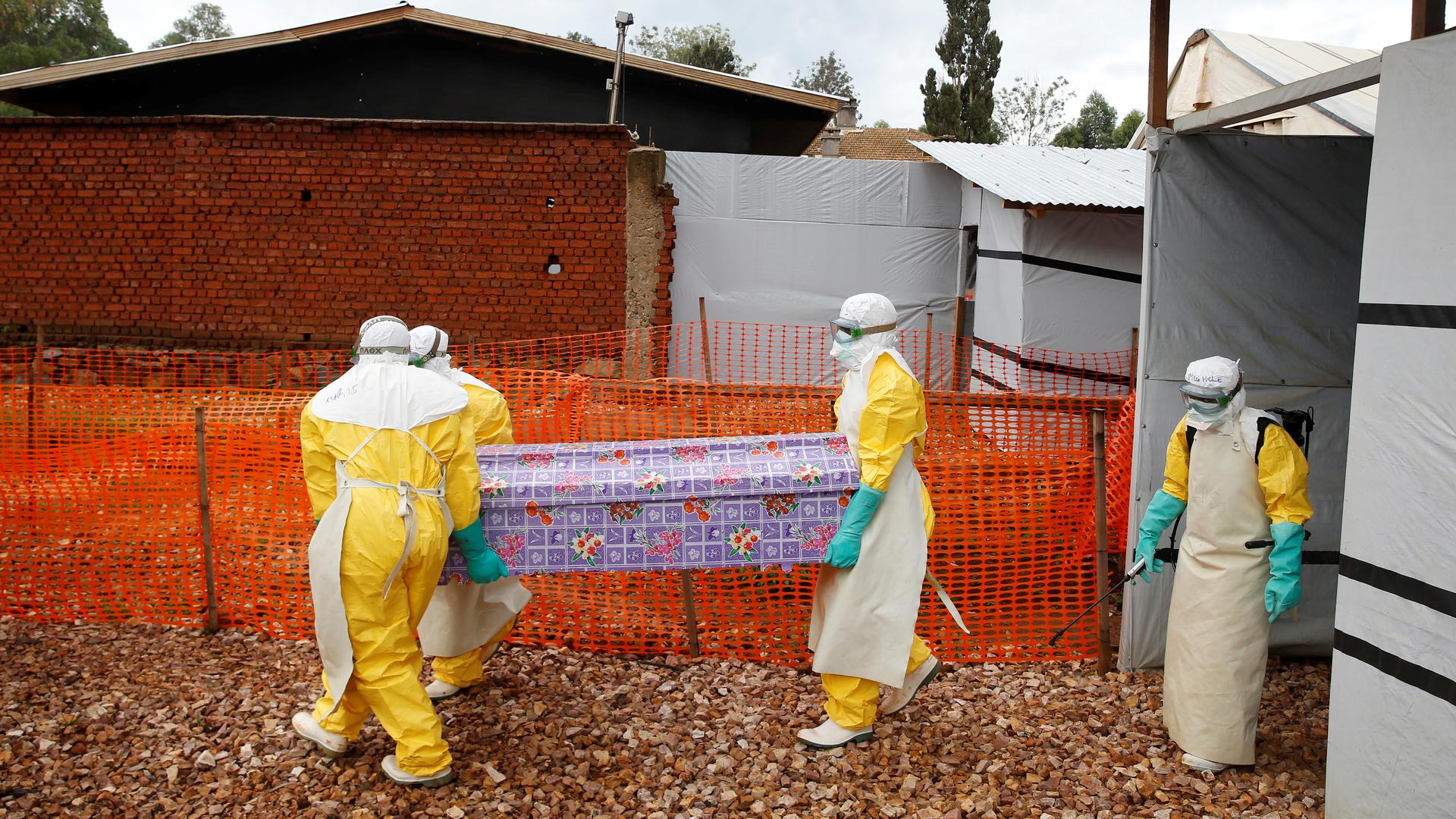workers carrying coffin of a victim of ebola