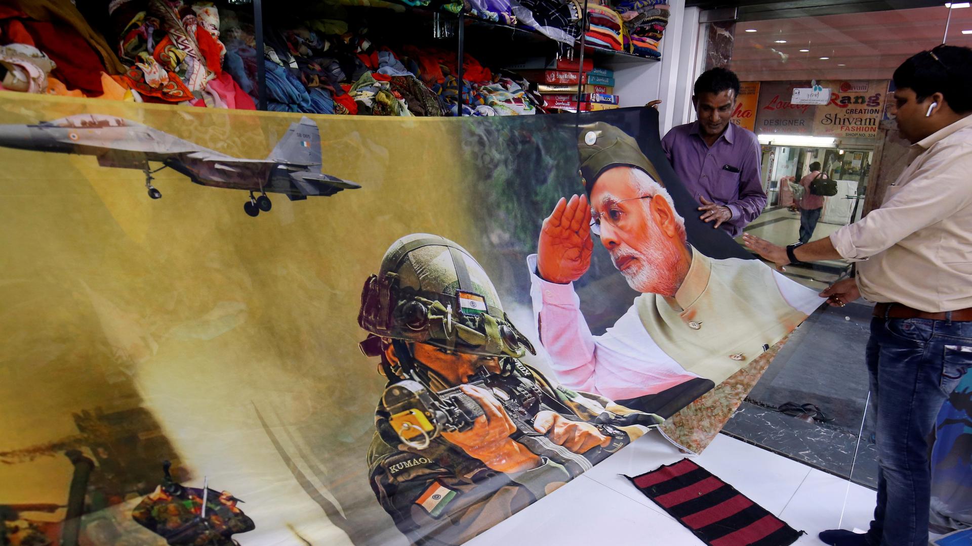 Trader displays sari with image of modi with his military tanks
