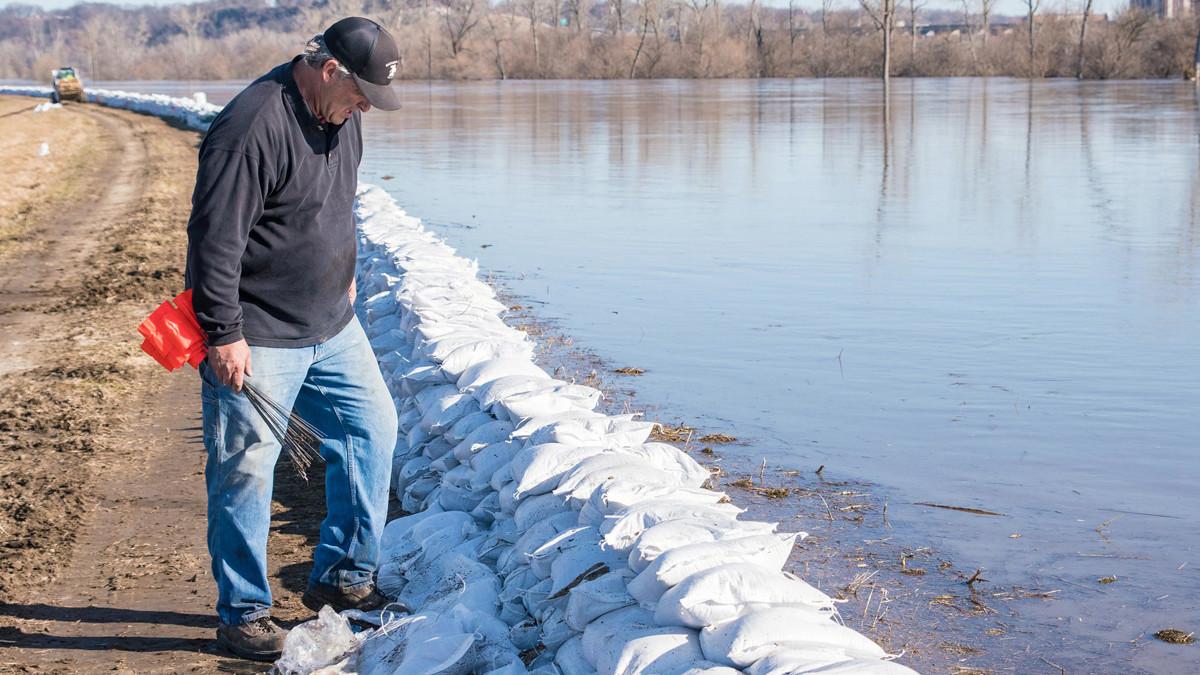 a man inspects a levee in kansas