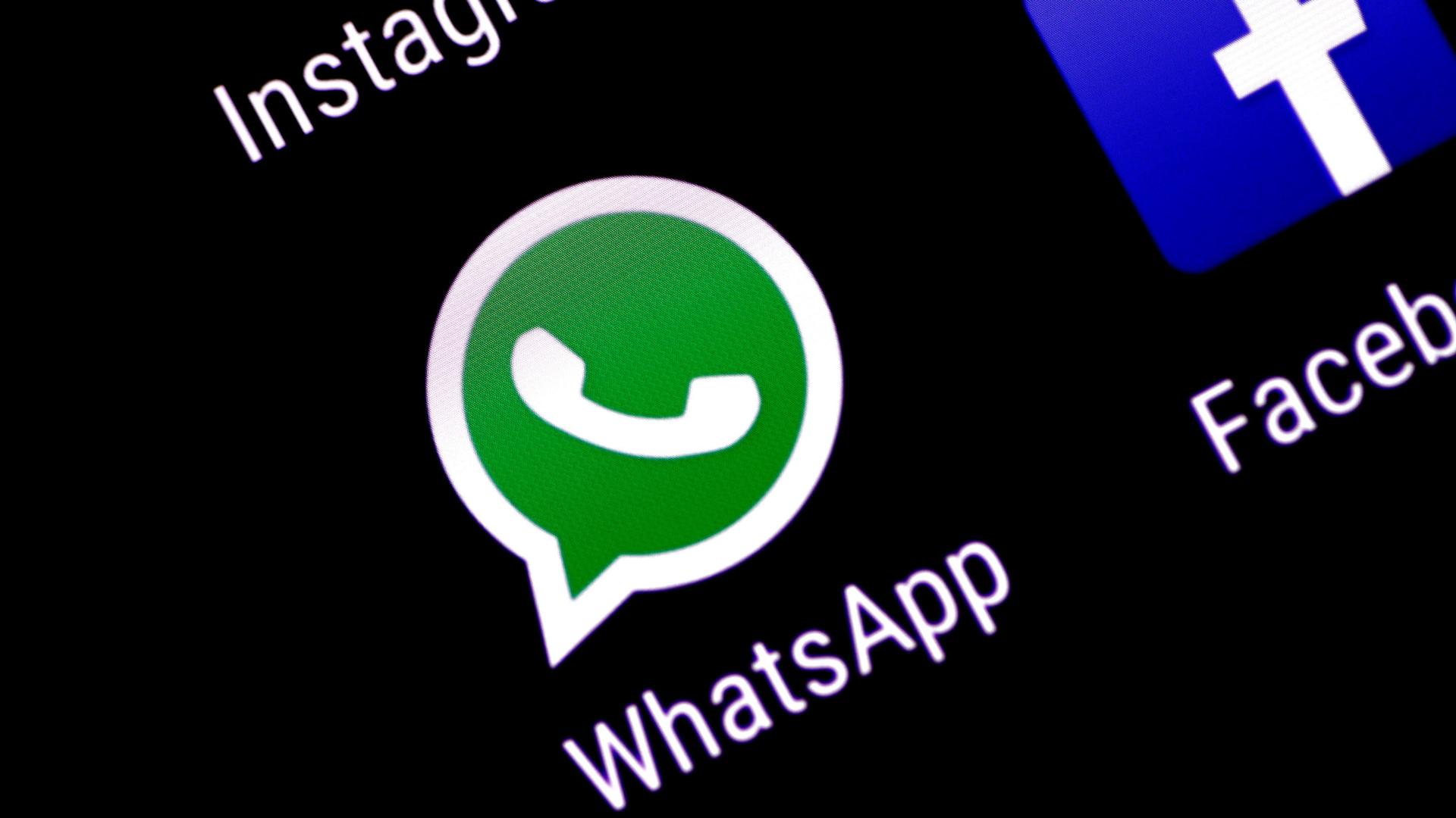 WhatsApp's green and white chat bubble icon is shown on a phone screen.