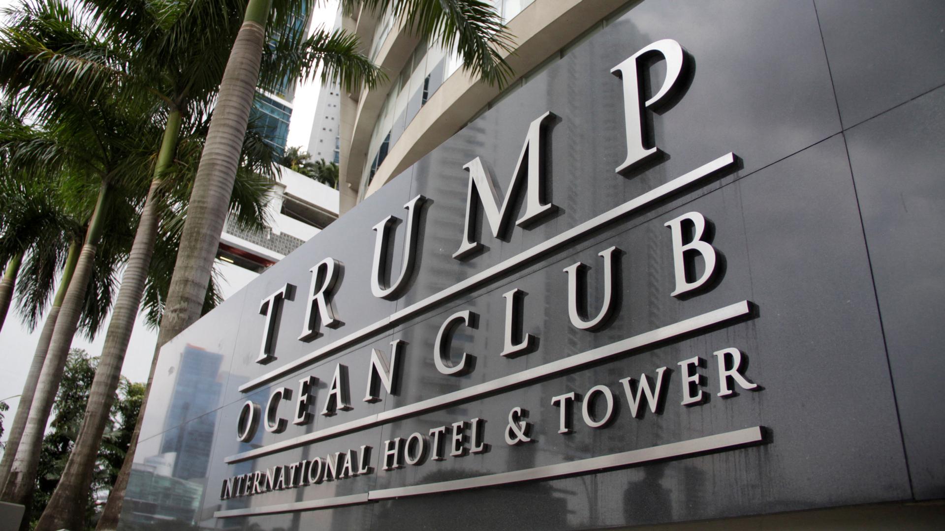 A sign of the Trump Ocean Club International Hotel and Tower Panama with silver lettering on a large marble block.