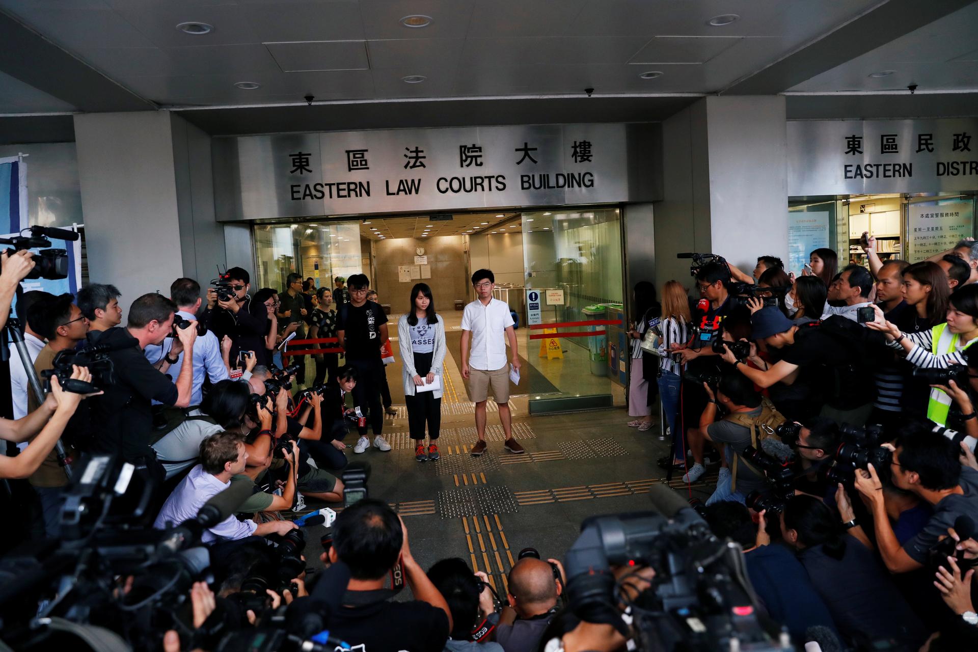 Pro-democracy activists Joshua Wong and Agnes Chow leave the Eastern Court after being released on bail in Hong Kong, China, on August 30, 2019.