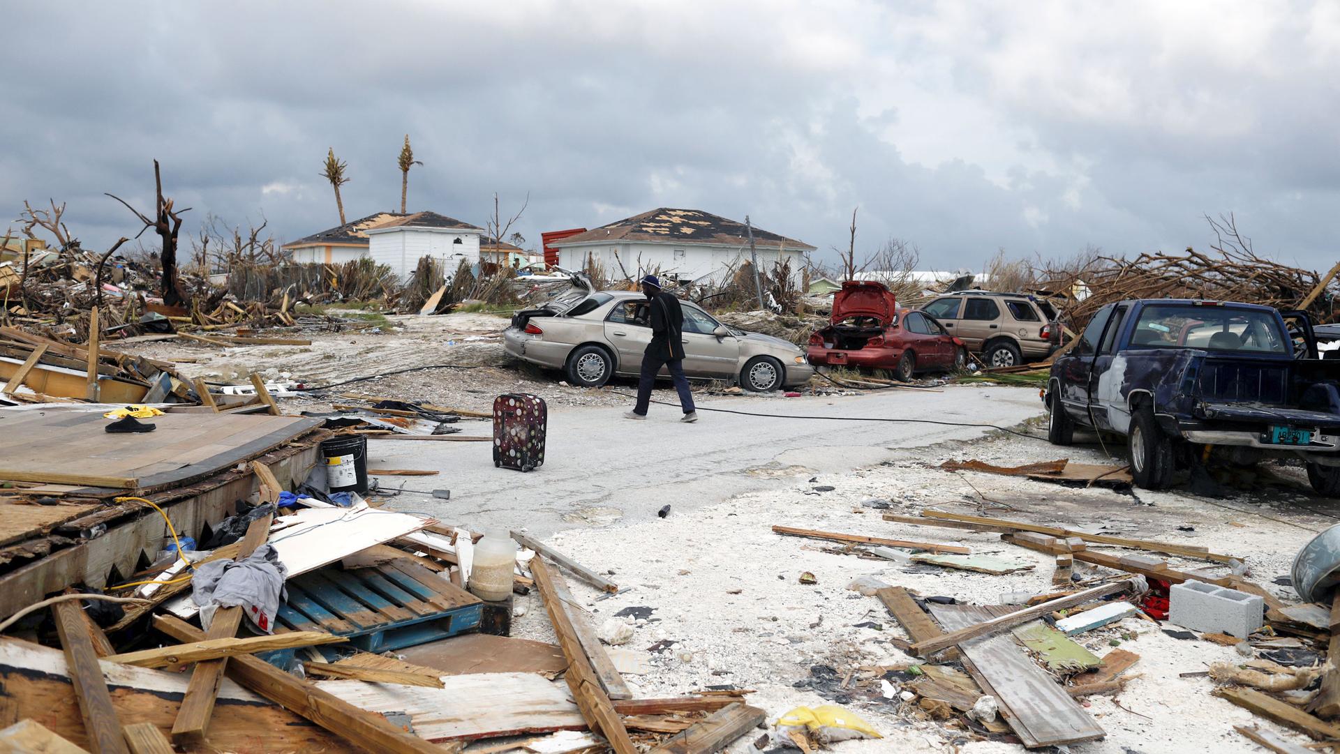 A man walks through debris