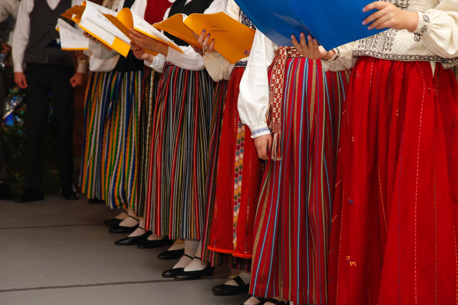 A row of multi-colored woolen skirts