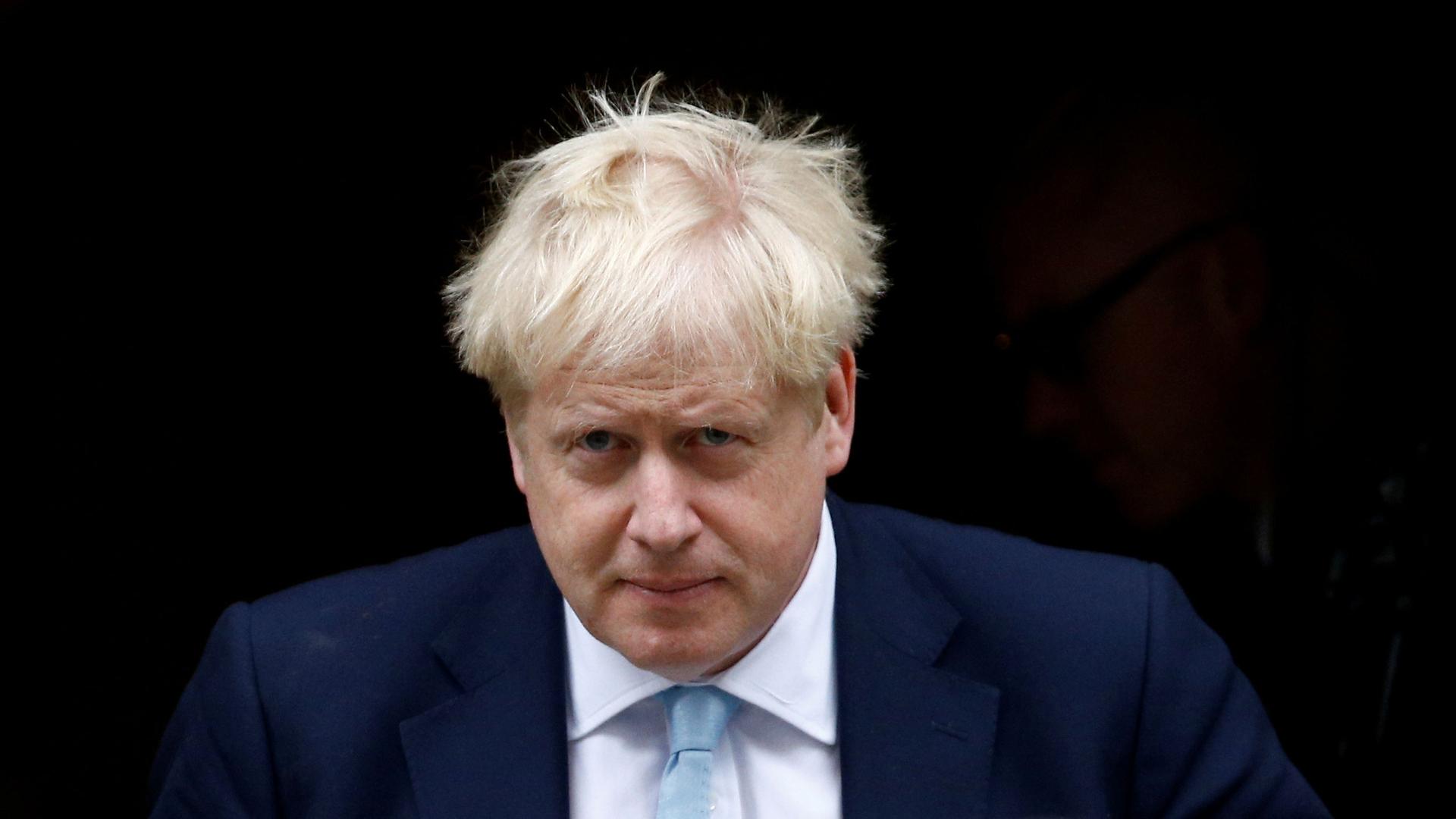 British Prime Minister Boris Johnson leaves his Downing Street office.