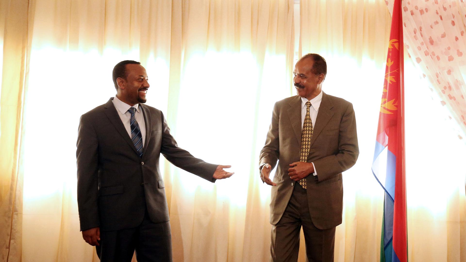 Eritrea's President, Isaias Afwerki, talks to Ethiopia's Prime Minister, Abiy Ahmed during the Inauguration ceremony marking the reopening of the Eritrean Embassy in Addis Ababa, Ethiopia, on July 16, 2018.