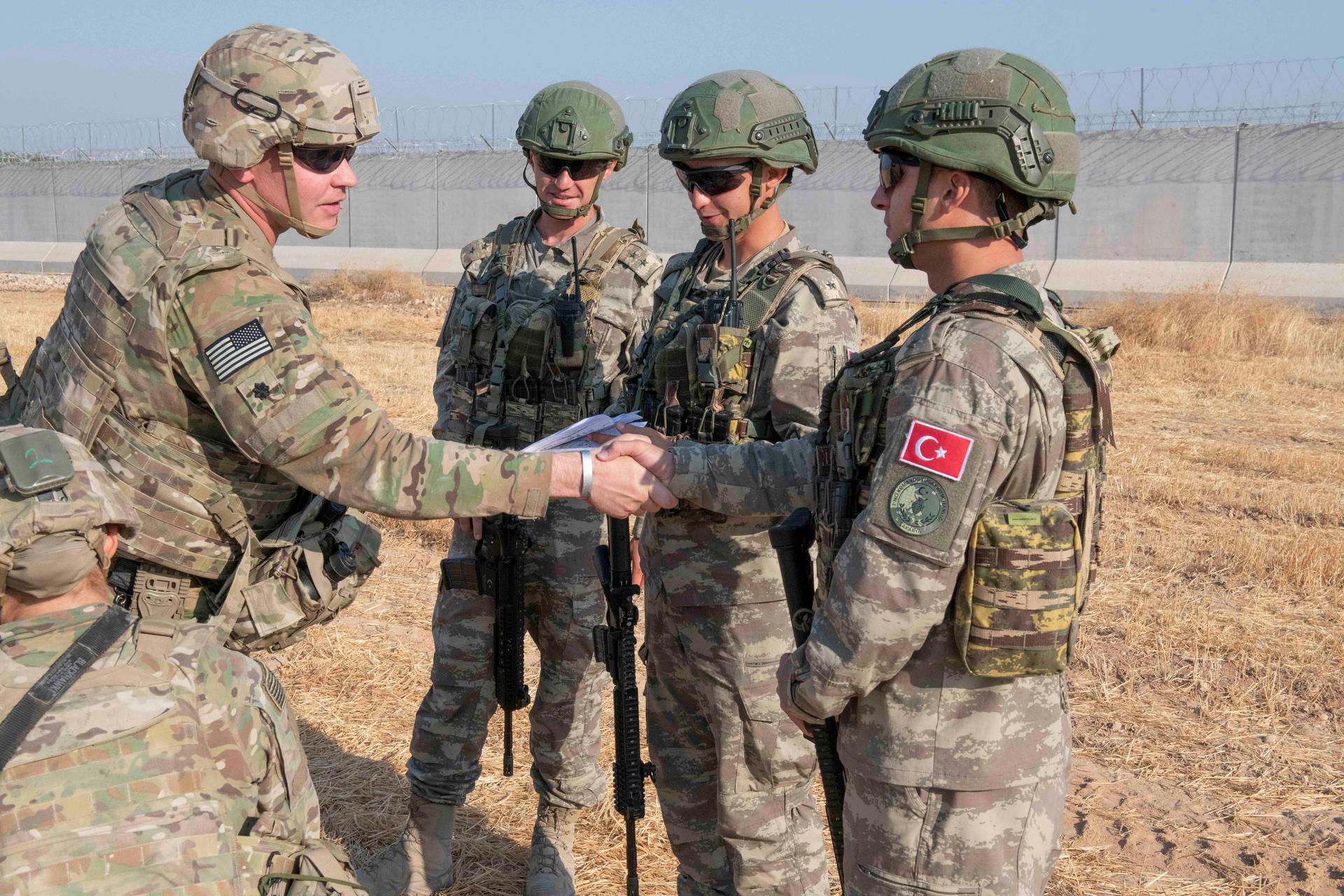 US and Turkish military forces conduct a joint ground patrol inside the security mechanism area in northeast, Syria, October 4, 2019.