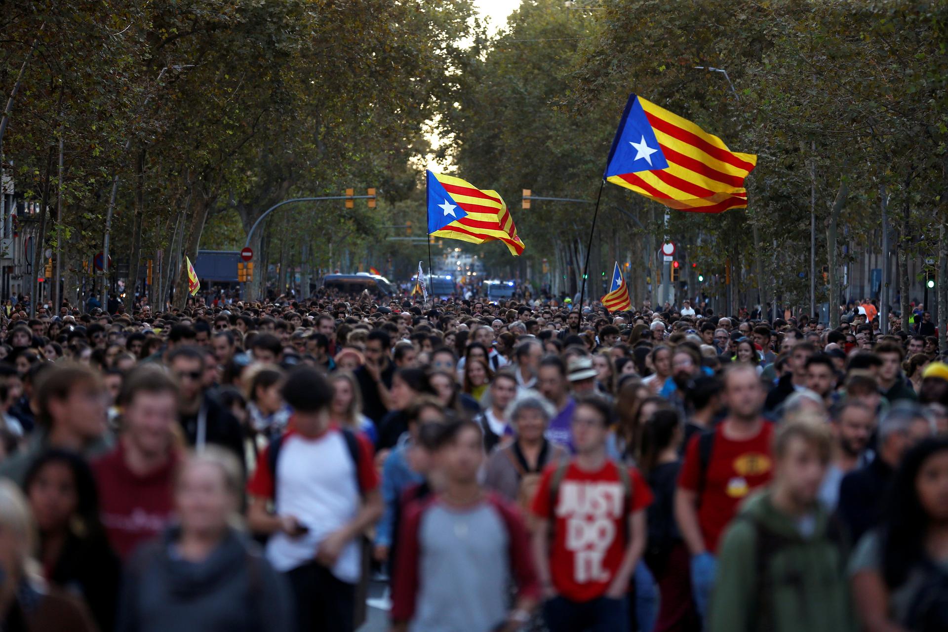 Mass protests in Barcelona with protesters carrying flags