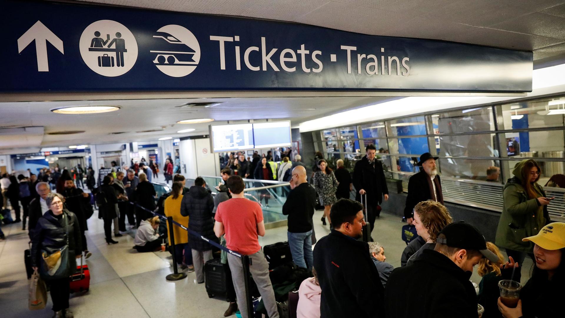 Travelers wait in the boarding area for trains during the Thanksgiving holiday travel rush at Pennsylvania Station in New York, US, on Nov. 27, 2019.