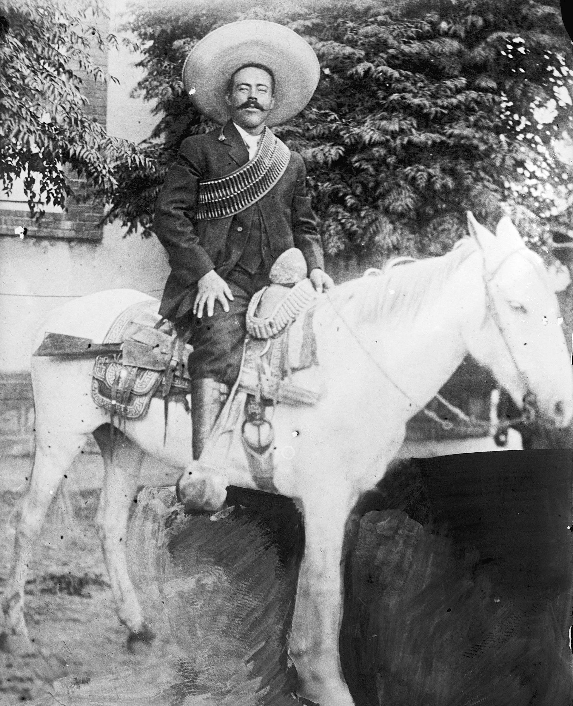 a black and white photograph of Pancho Villa on a white horse