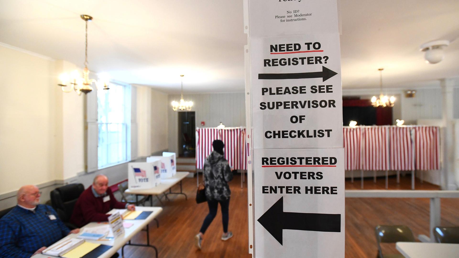 Signs direct voters at a polling place in the state's presidential primary election in Greenfield, New Hampshire, Feb. 11, 2020.