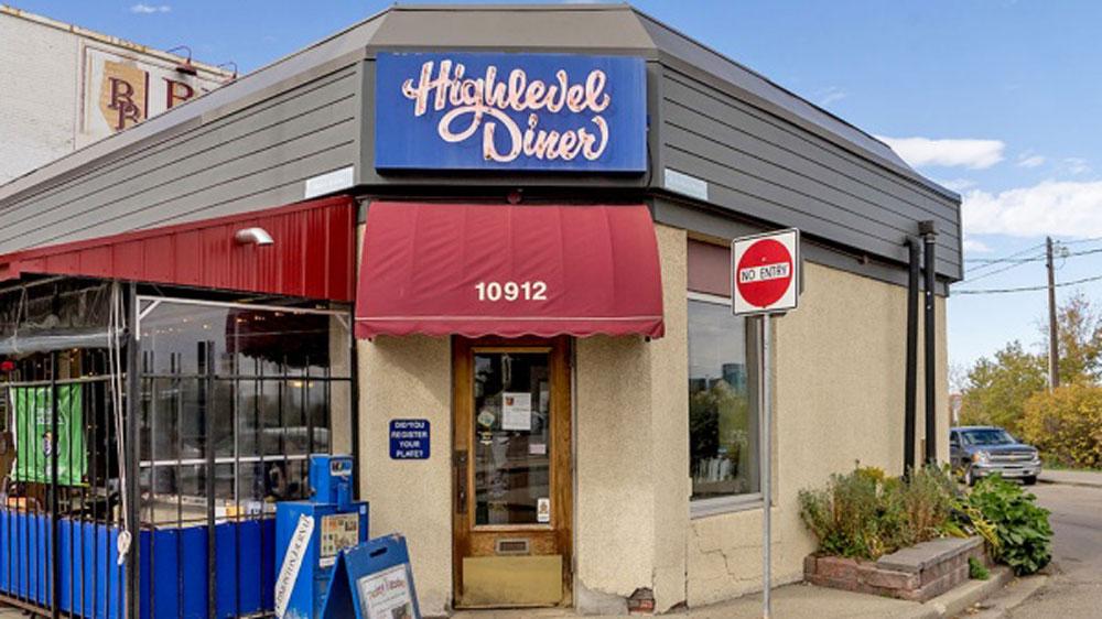 The blue Highlevel Diner sign sits above the diner’s door in Edmonton, Canada.