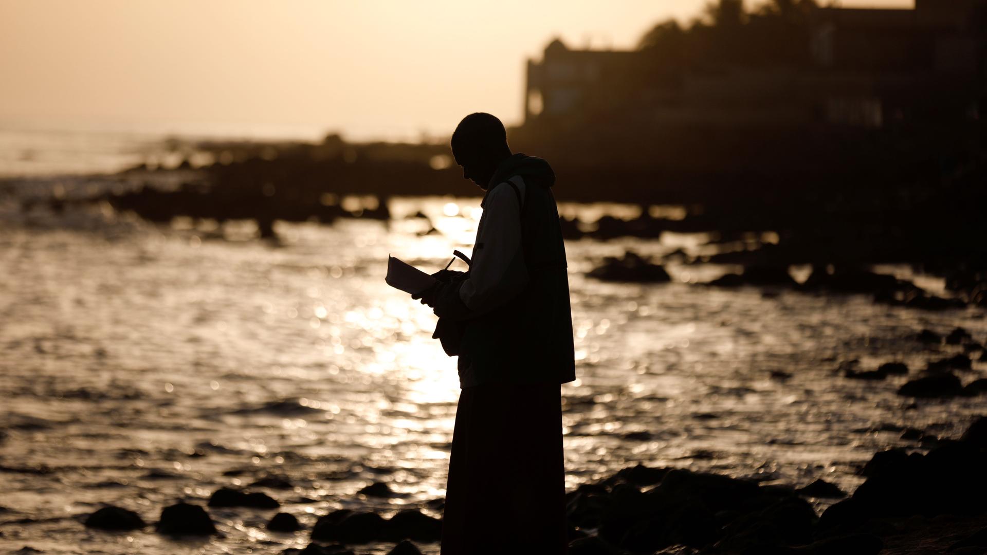 A man meditates at the beach amid the outbreak of the coronavirus disease (COVID-19), in Dakar, Senegal, March 26, 2020.