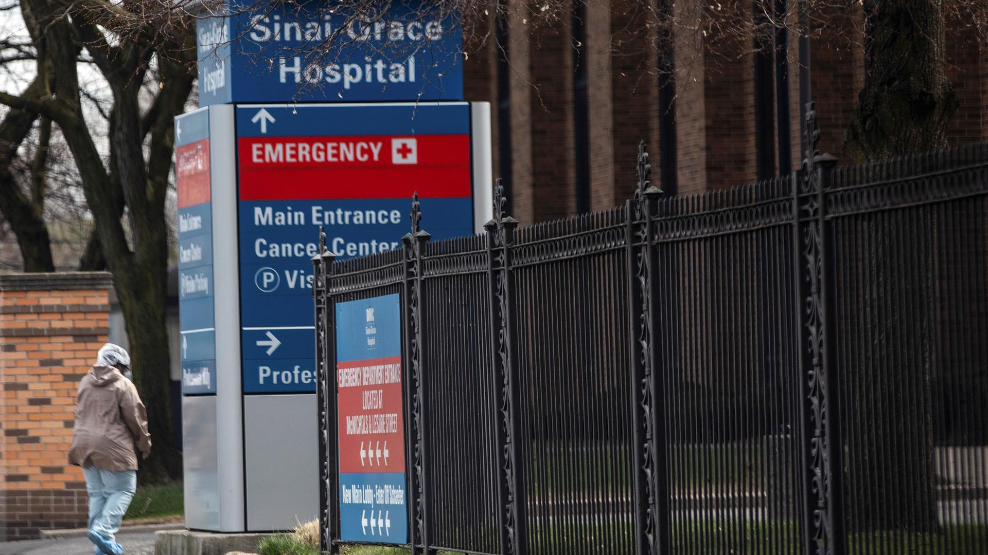 A healthcare worker walks outside the DMC Sinai-Grace Hospital
