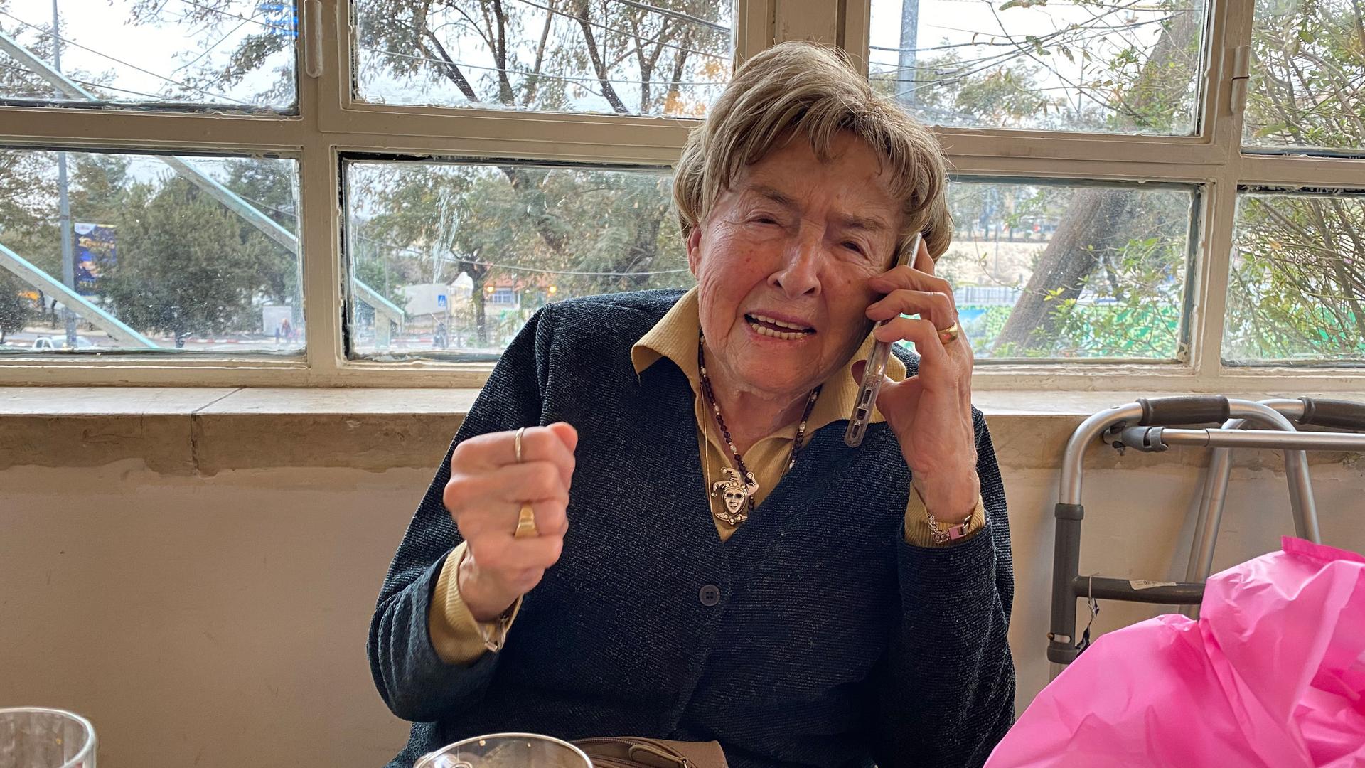 An older woman speaks on the phone