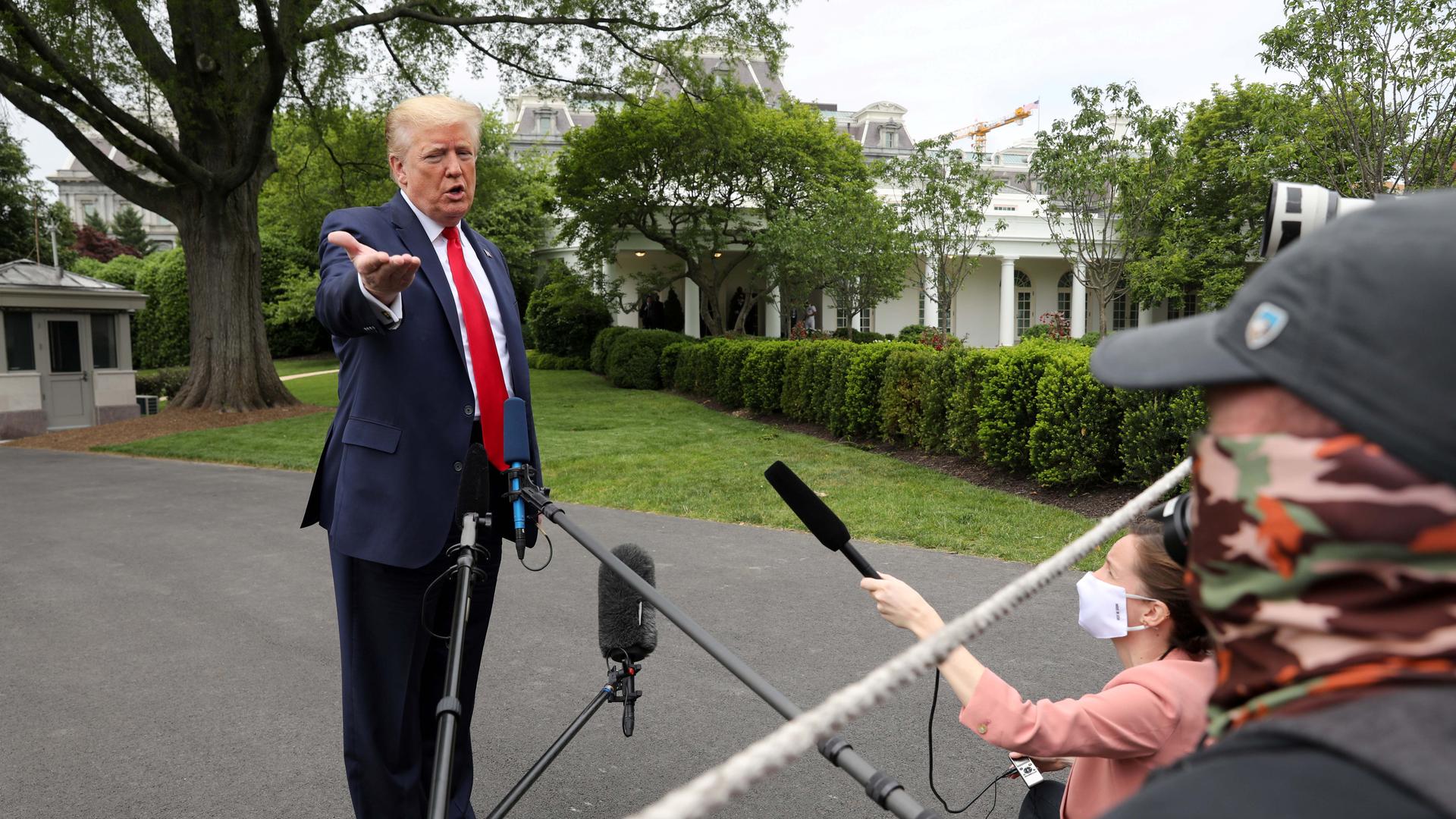 US President Donald Trump speaks to reporters as he departs the White House for travel to Michigan during the coronavirus disease (COVID-19) outbreak in Washington, DC, on May 21, 2020.