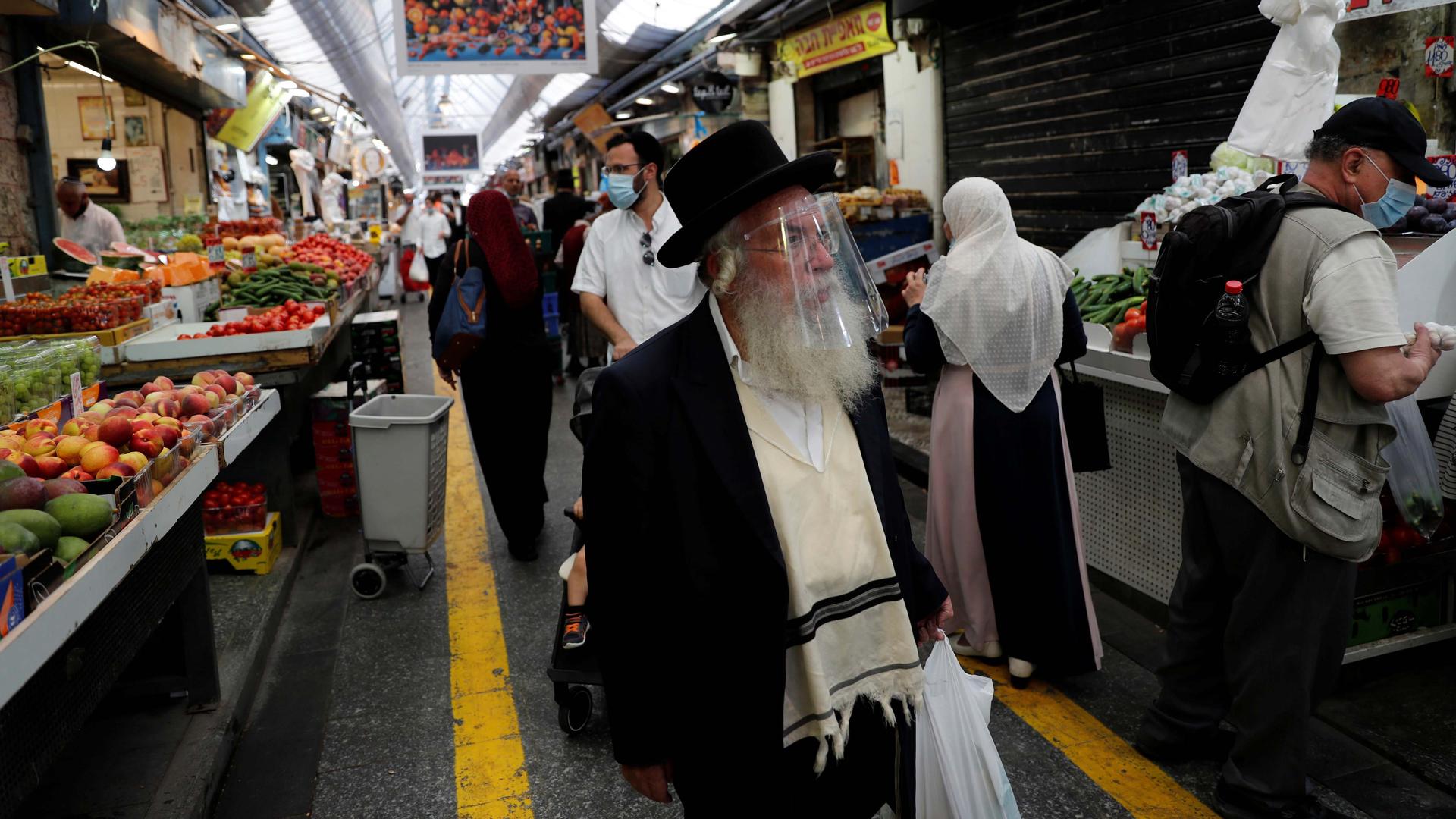 People wear face masks as they shop in a main market in Jerusalem, Israel, July 16, 2020.