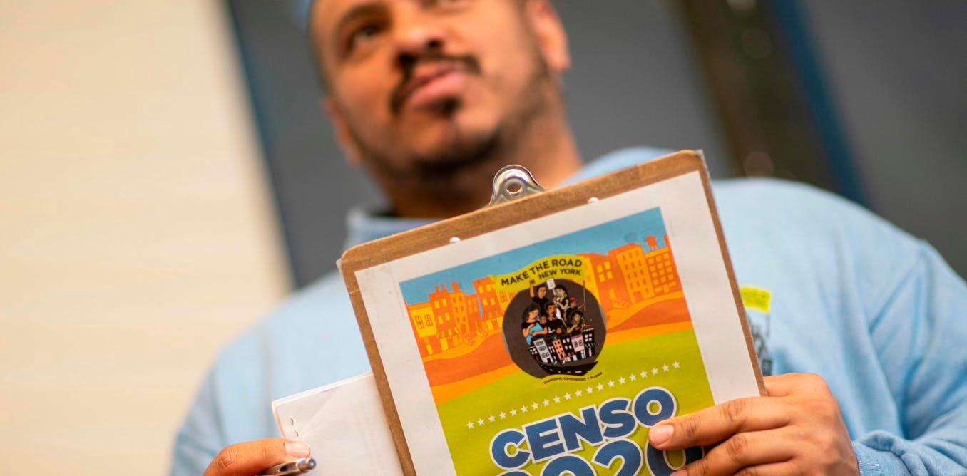 Douglas Carrasquell of the organization Make the Road New York holds documents as he attends a training meeting about National Census in Queens on March 13, 2020 in New York City