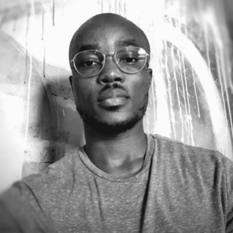A black and white photo of a man wearing glasses.