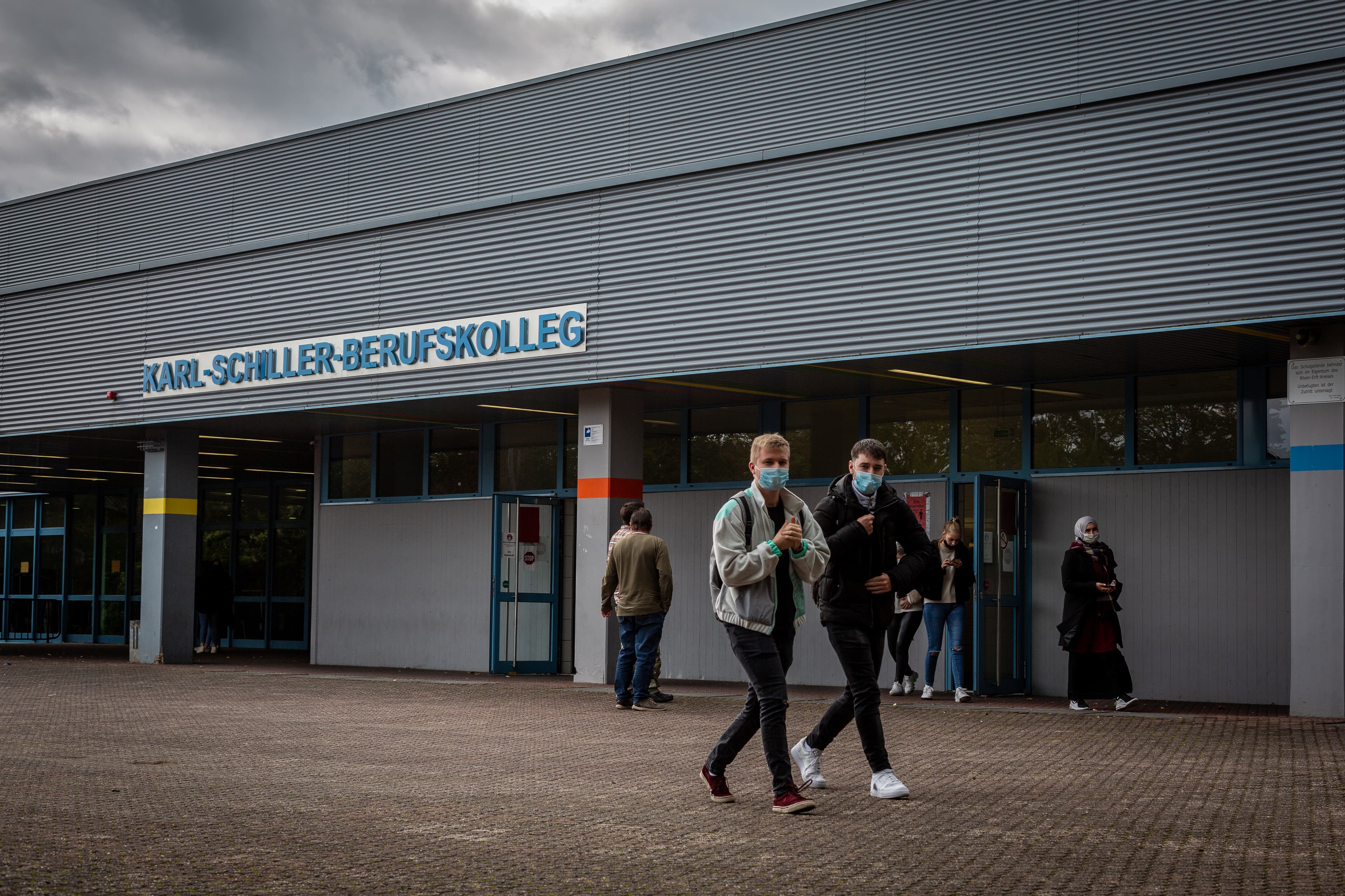 Students leave Karl-Schiller-Berufskolleg in Brühl, a secondary school outside of Cologne, Germany. Students are required by the school to wear masks on schools grounds.