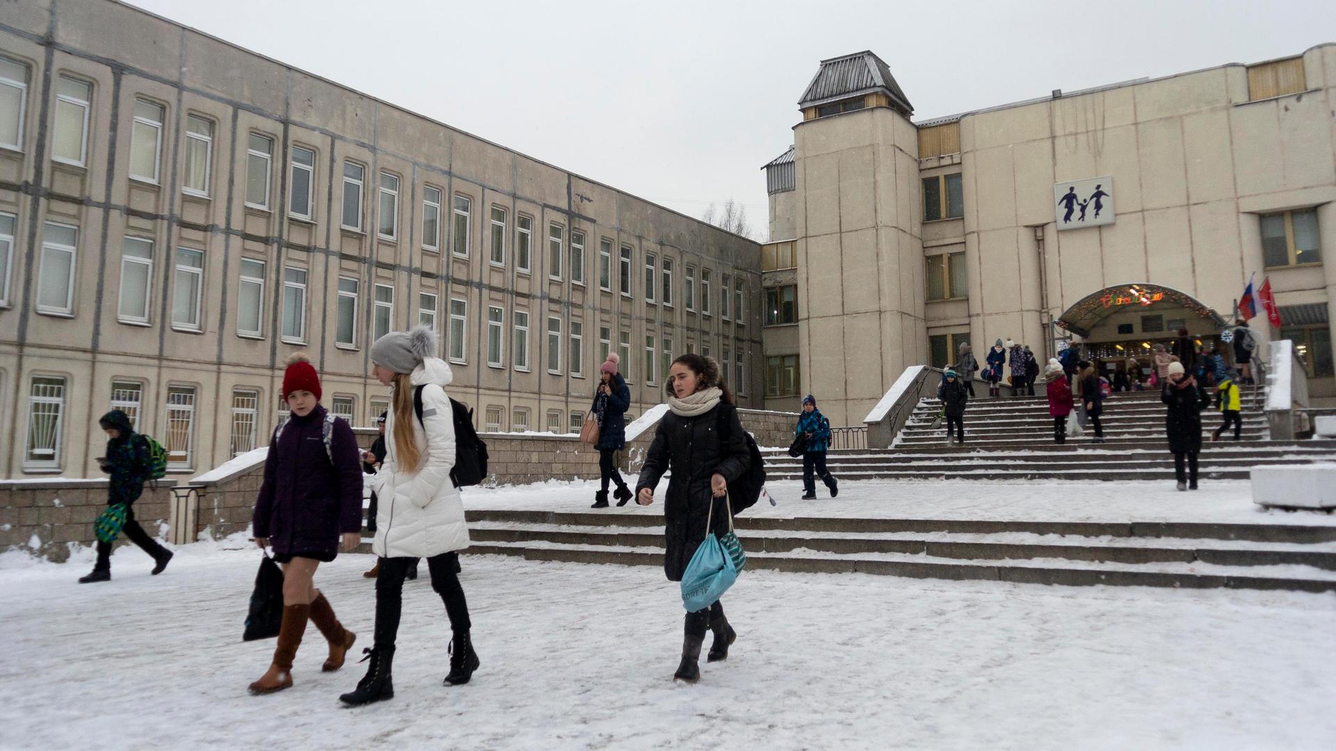 In this photo taken on Thursday, Dec. 20, 2018, students come out of a school building in St. Petersburg, Russia.