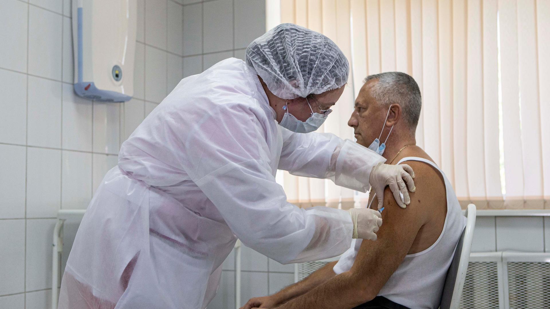 In this Sept. 15, 2020, file photo, a Russian medical worker administers a shot of Russia's experimental Sputnik V coronavirus vaccine in Moscow, Russia.