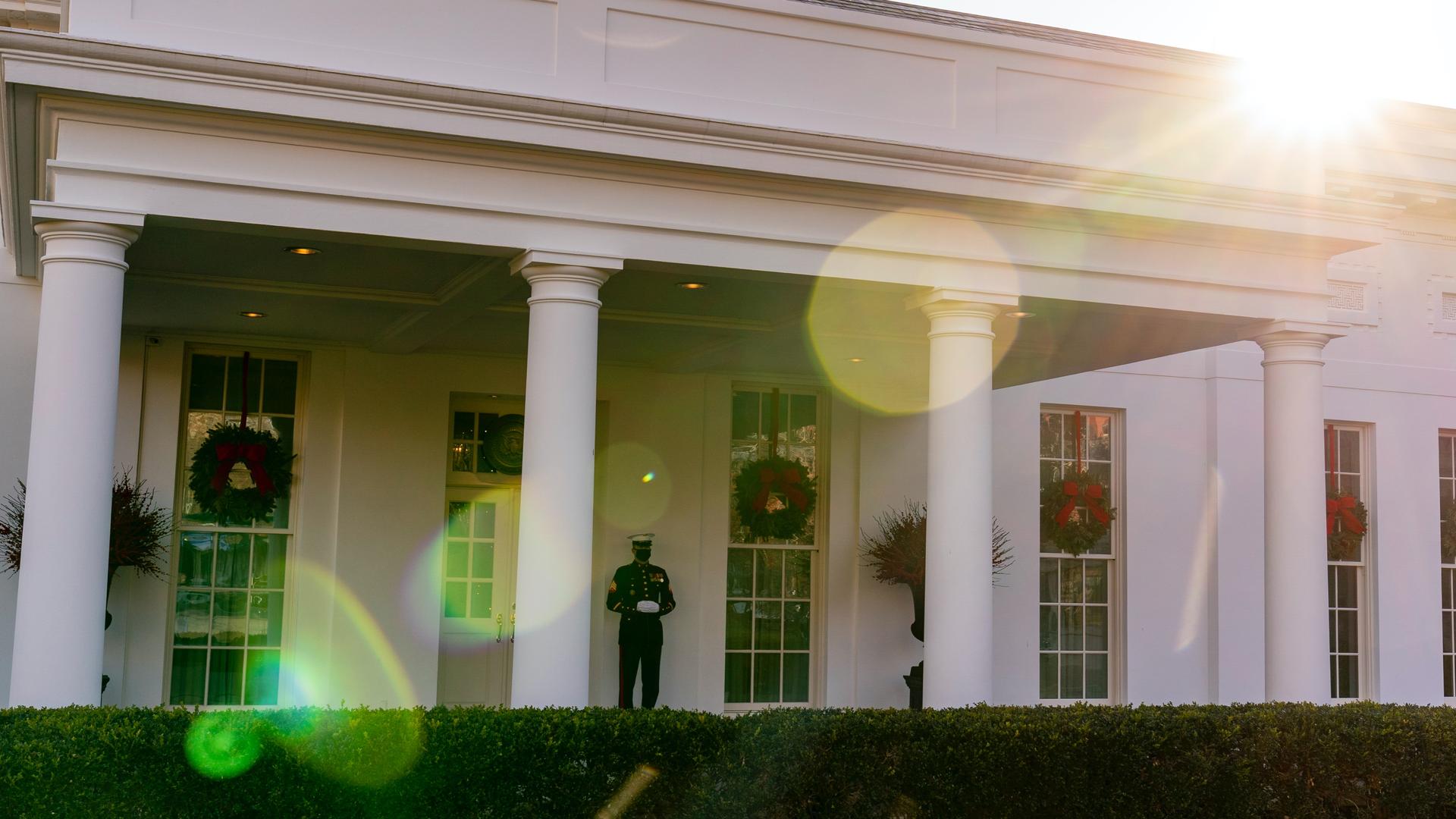 A Marine stands guard outside of the White House.