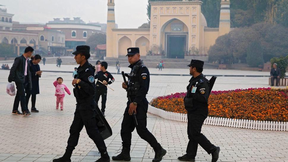 Uighur security personnel patrol near the Id Kah Mosque in Kashgar in western China's Xinjiang region, Nov. 4, 2017. A Chinese Communist Party official signaled Monday, Dec. 21, 2020, that there would likely be no let-up in its crackdown in the Xinjiang r