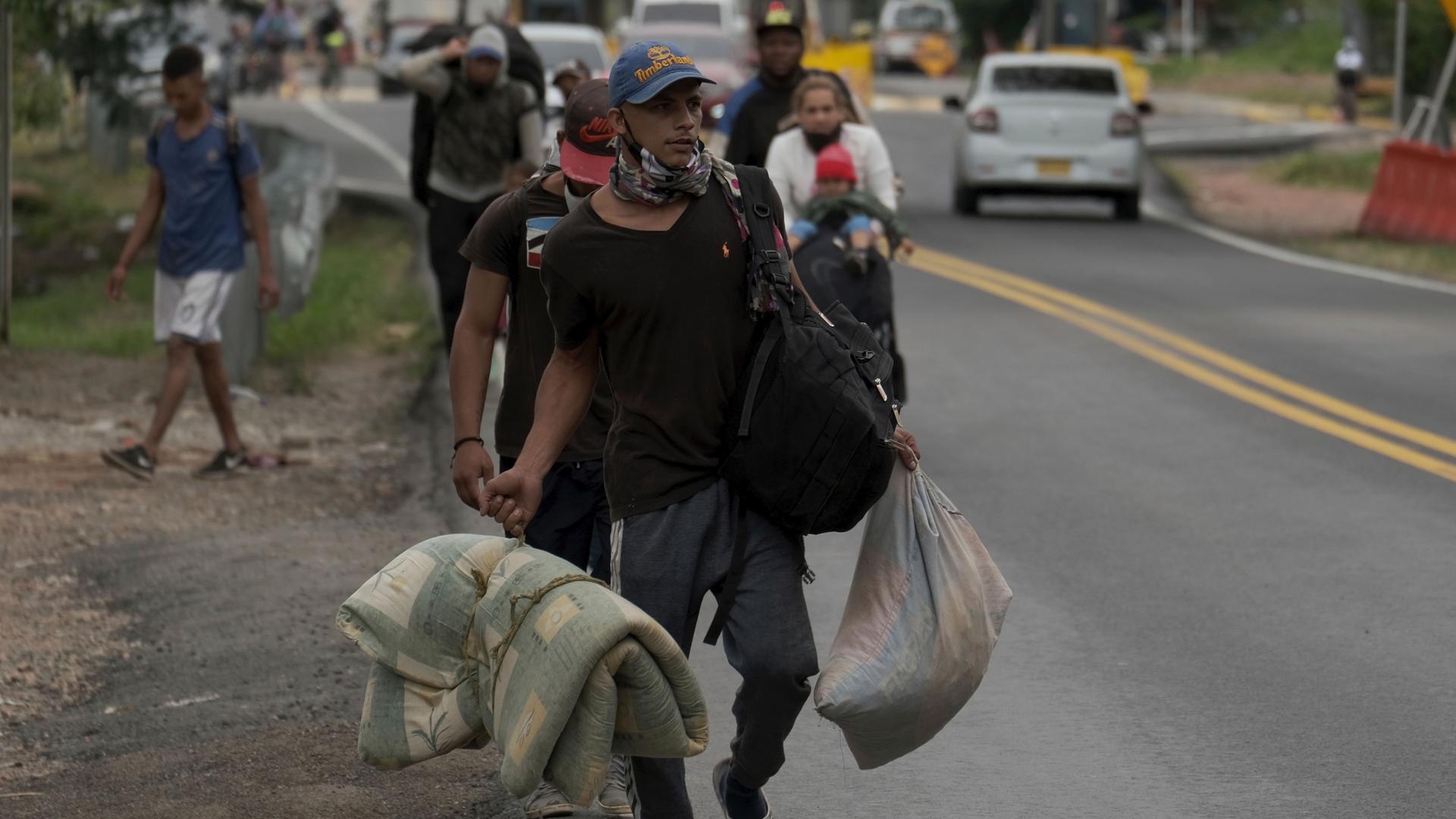 A Venezuelan migrant family walks away from the Venezuelan border in Pamplona, Colombia, Oct. 7, 2020. 
