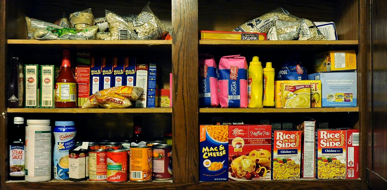 A pantry cabinet with a variety of food packages