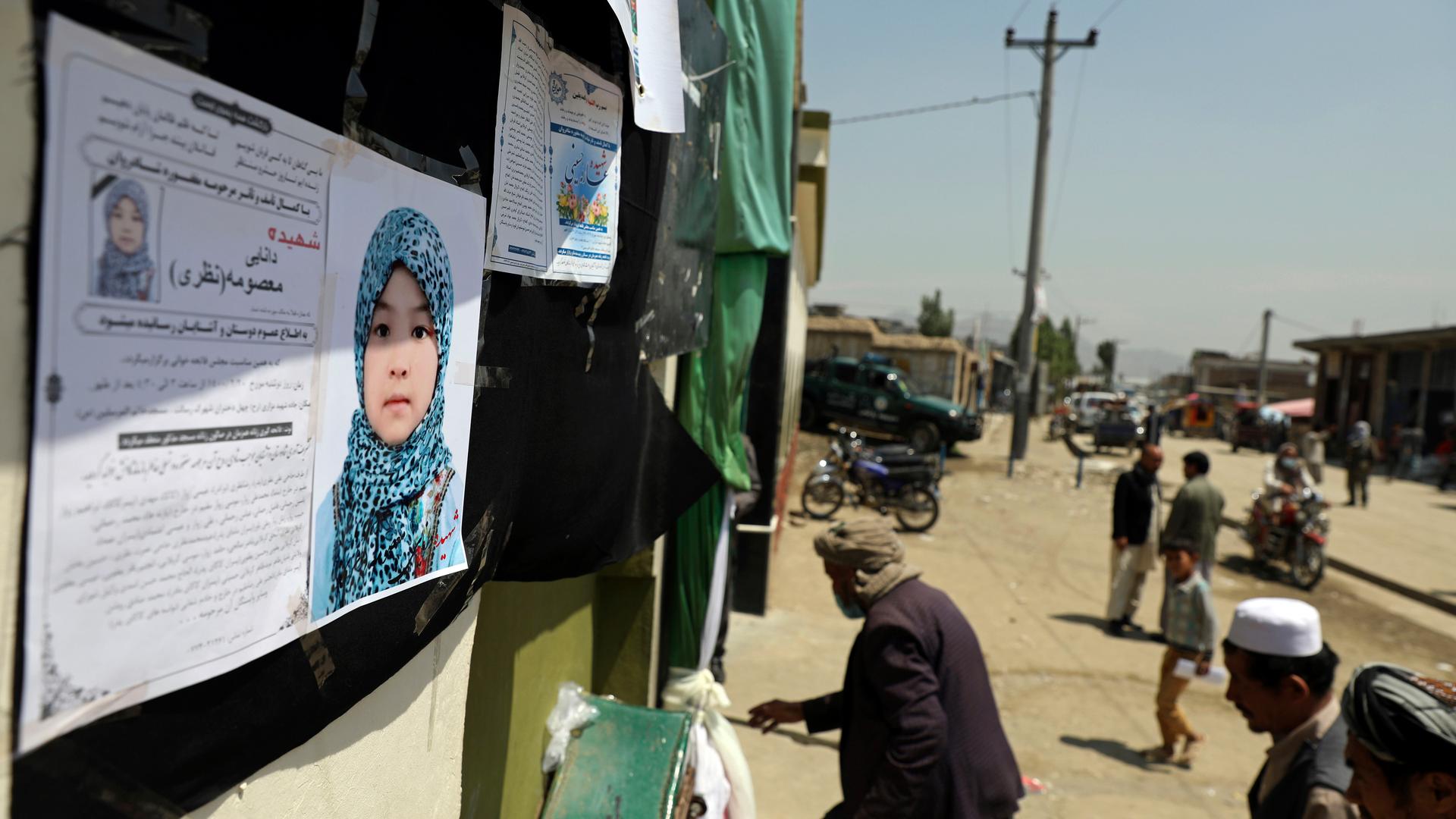 Afghans arrive at a memorial ceremony for Masooma Nazari, a student who was killed by deadly bombings on Saturday.