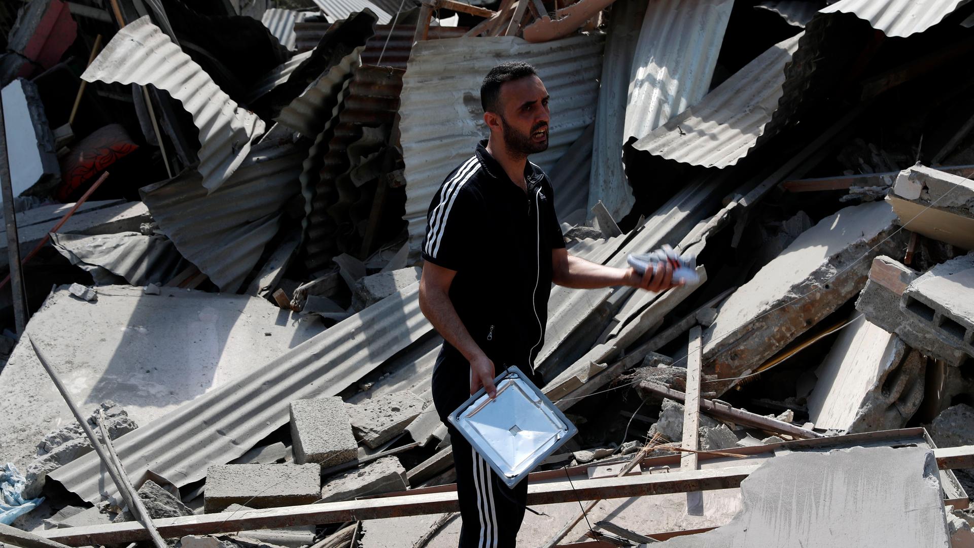 A man inspects the rubble of destroyed residential building, which was hit by Israeli airstrikes, in Gaza City