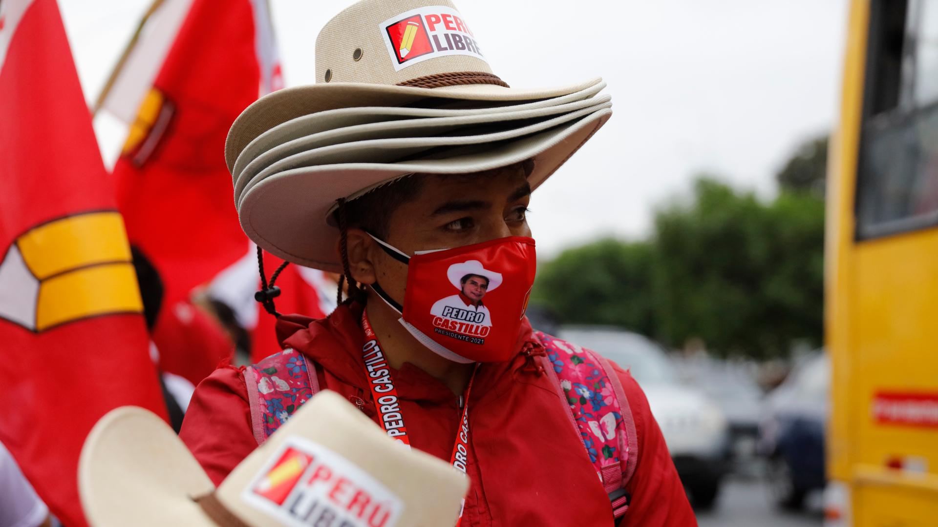 A vendor sells hats at the closing campaign rally for Free Peru party presidential candidate Pedro Castillo in Lima, Peru, Thursday, June 3, 2021. The former rural school teacher will face rival candidate Keiko Fujimori in a June 6 election.