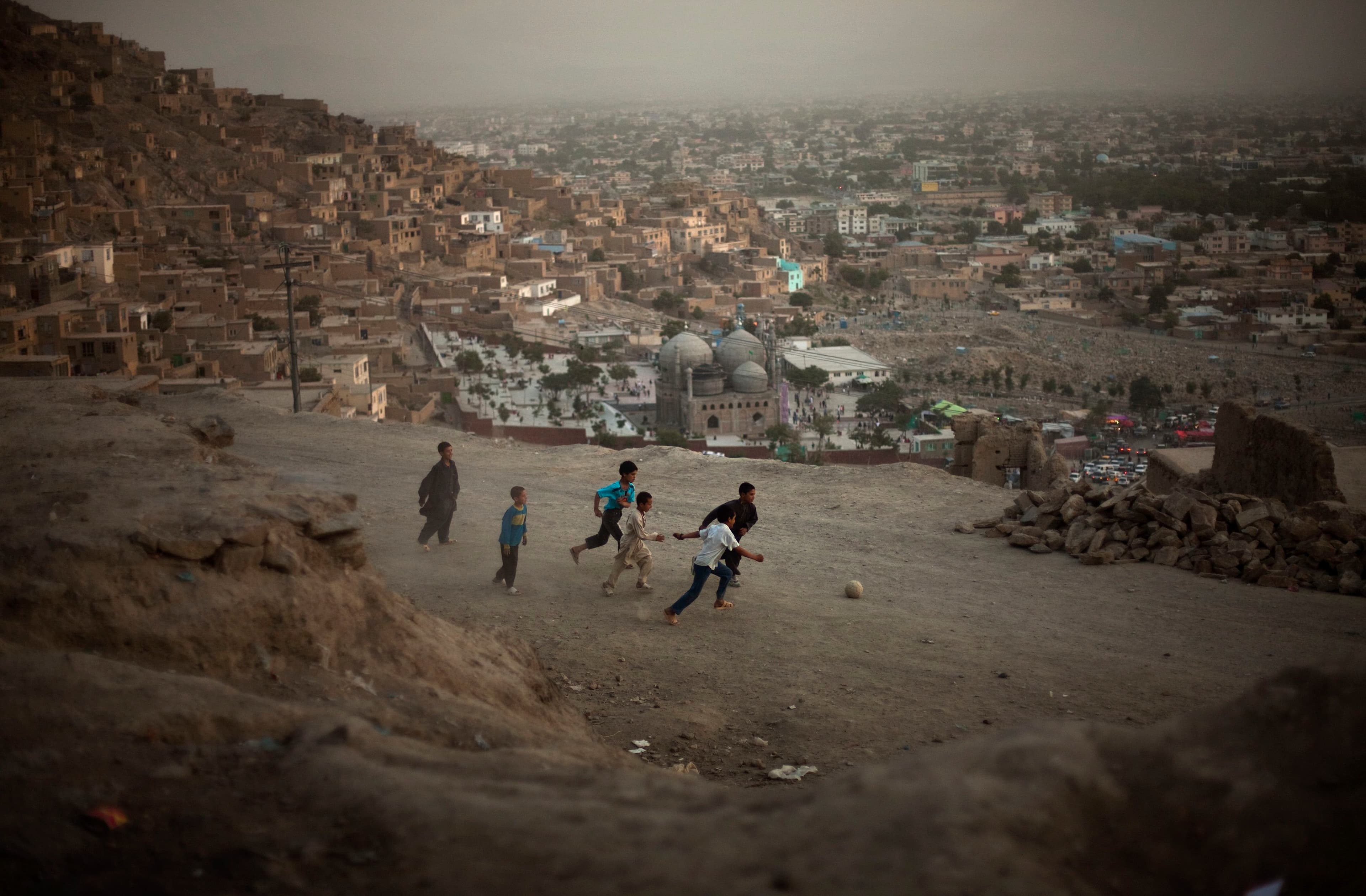 Afghan children play football in a street in Kabul, Afghanistan, on July 17, 2009.