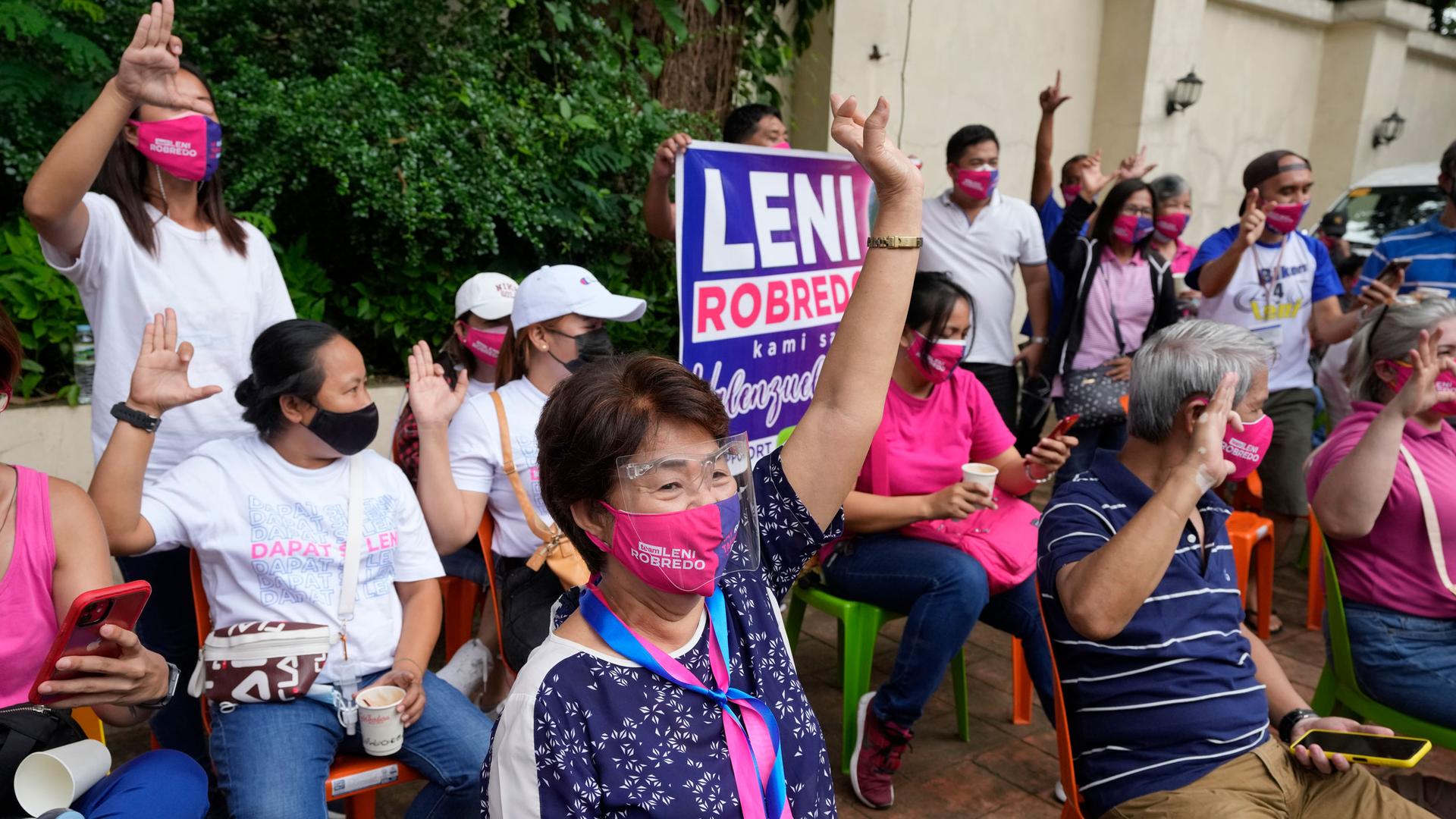 Supporters of Philippine Vice President Leni Robredo gesture as they wait for her to declare her bid to run for president in next year's elections in Quezon city, Metro Manila, Philippines on Thursday, Oct. 7, 2021. 