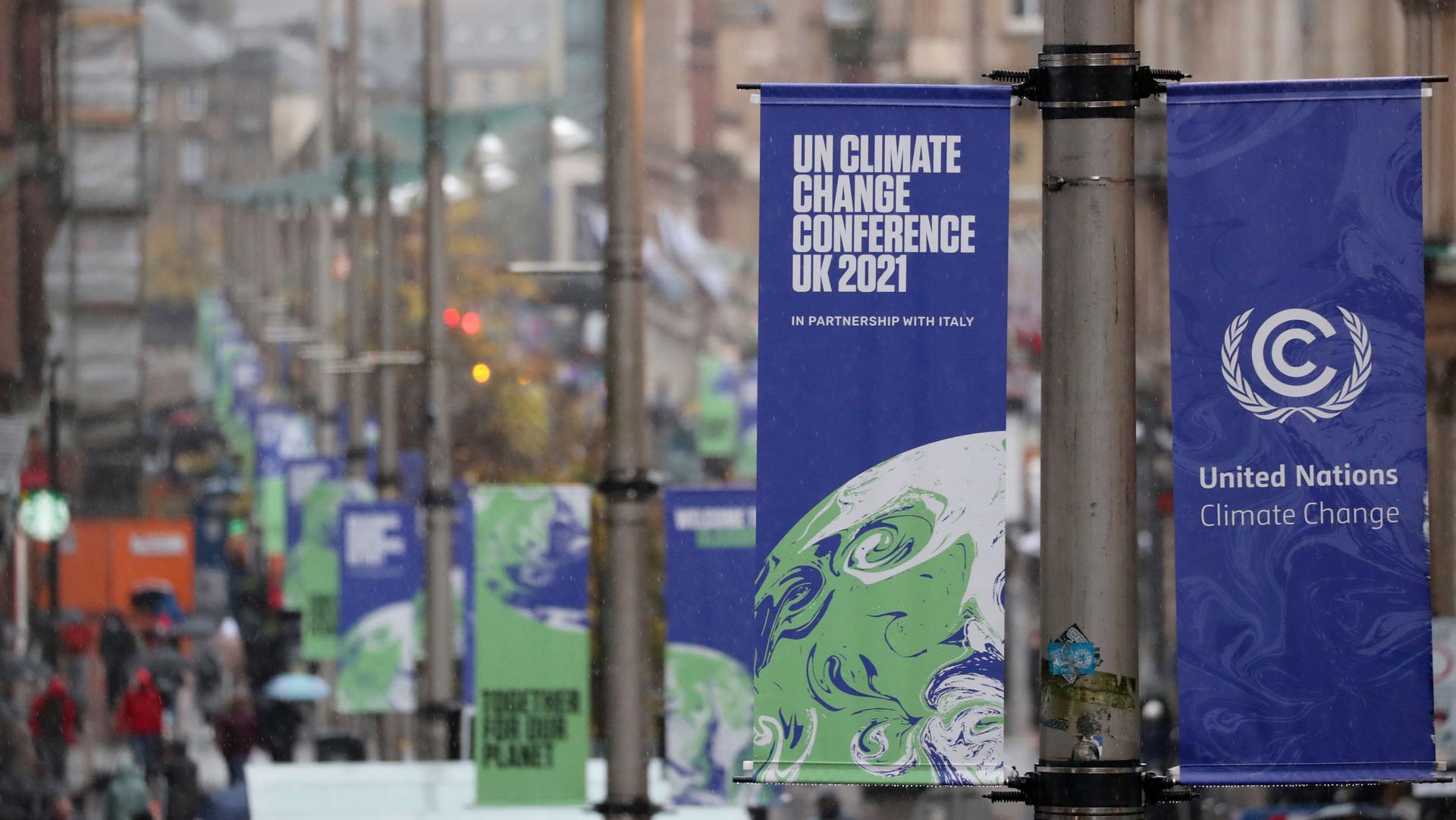 The view of banners displayed in central Glasgow, Scotland, Friday, Oct. 29, 2021. The UN climate conference COP26 starts Sunday in Glasgow. 