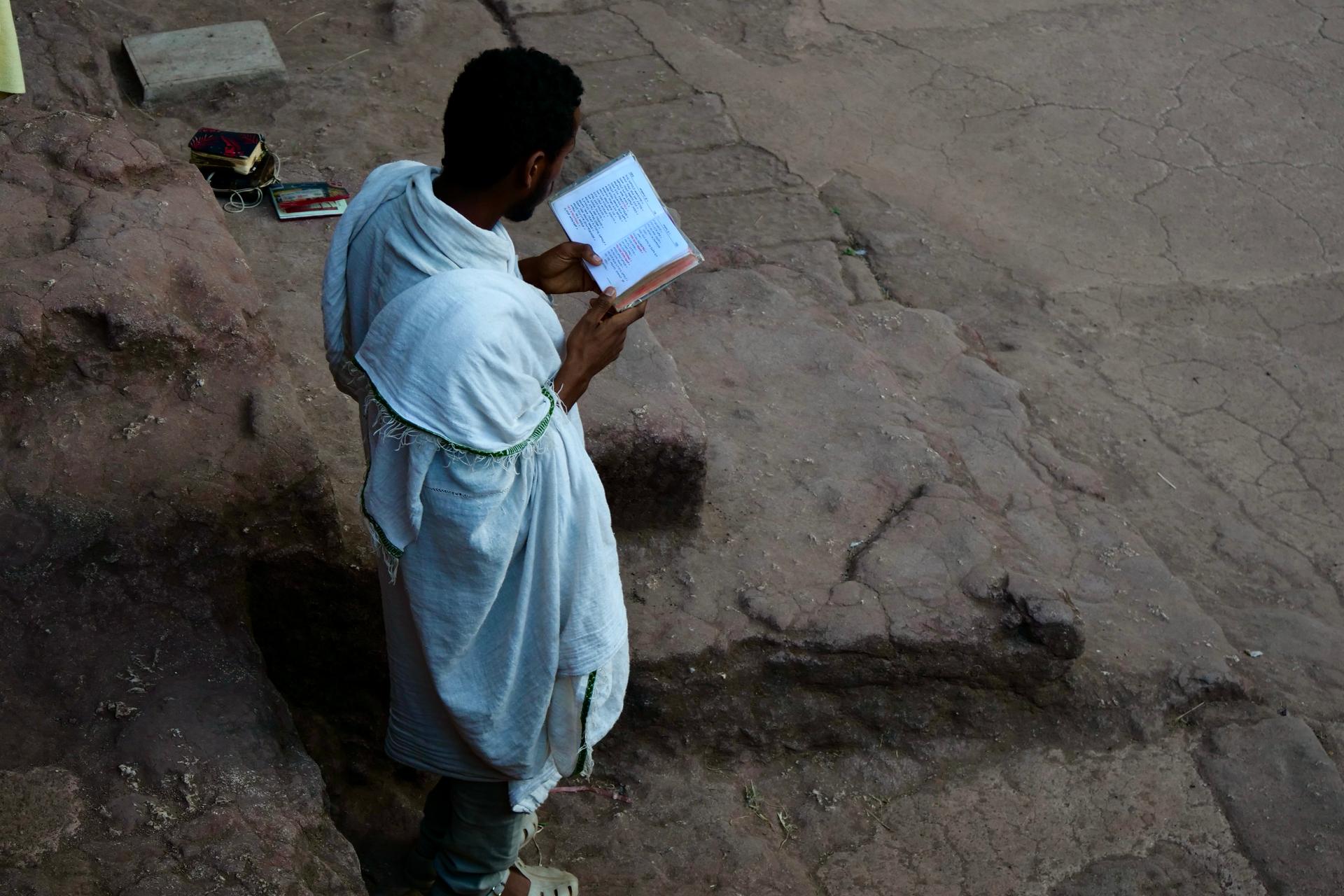 Young man prays at the Lalibela rock churches in Ethiopia, Feb. 16, 2022.