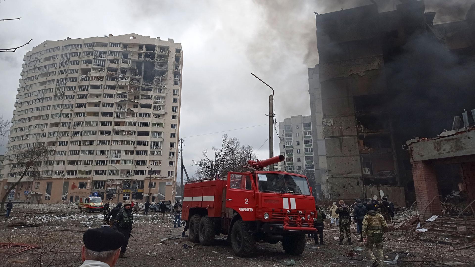 Firefighters work to extinguish a fire at a damaged city center after Russian air raid in Chernigiv, Ukraine, Thursday, March 3, 2022. 