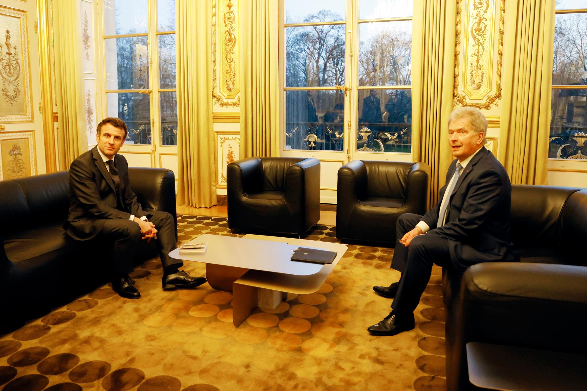 French President Emmanuel Macron, left, poses the President of Finland Sauli Niinisto before their talks at the Elysee Palace, March 21, 2022 in Paris.