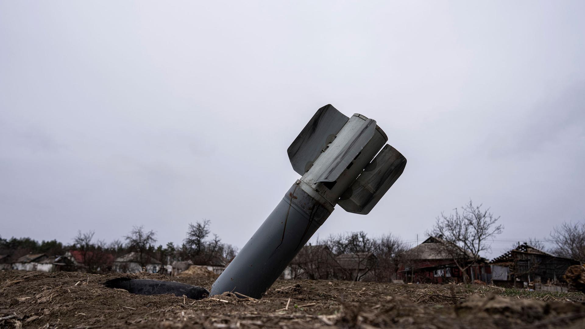 The tail of a missile sticks out in a residential area in Yahidne, near of Dnipro, Ukraine, Tuesday, April 12, 2022. 