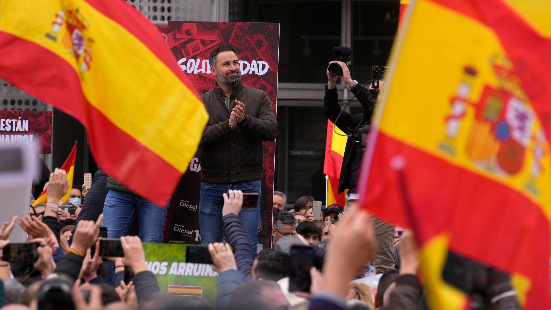 VOX party leader Santiago Abascal applauds supporters before making a speech during a rally by the extreme right wing party VOX in Madrid, Spain, Saturday, March 19, 2022. 
