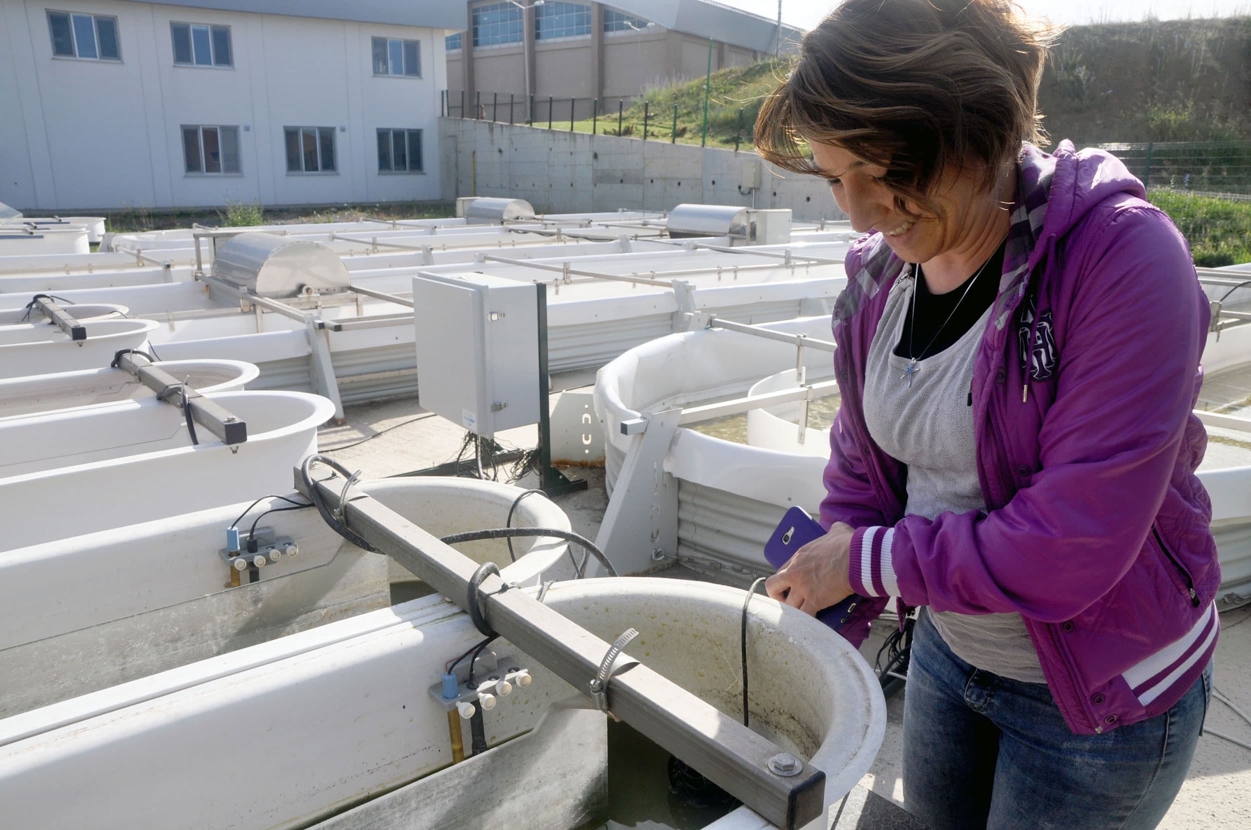 Irem Karamollaoğlu, project expert for the lab, checks a motor in an algae seeding pool at the Istanbul Microalgae Biotechnologies Research and Development Center. After growing in small pools, the algae is transferred to the larger racetrack ponds for a