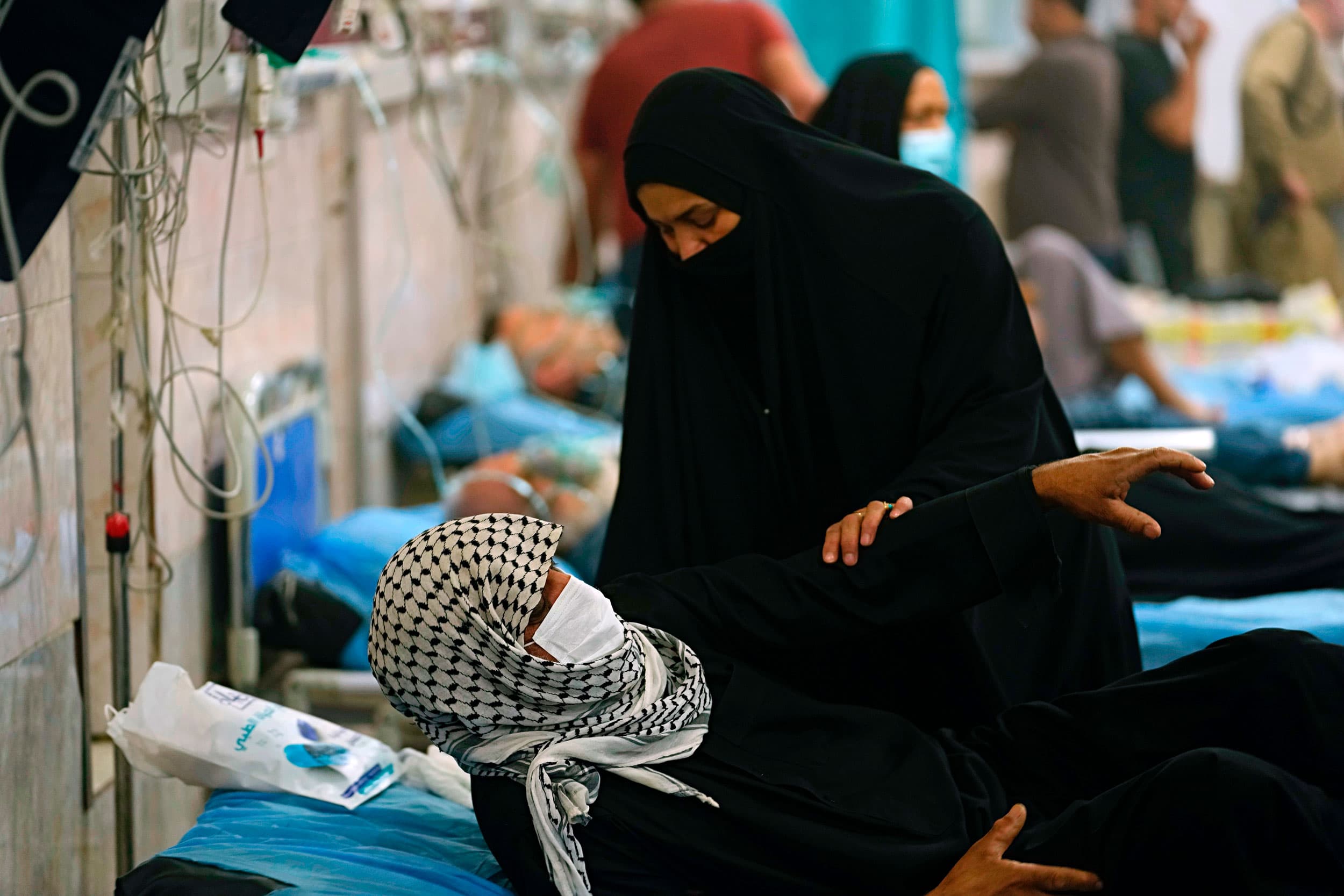 People with breathing problems are treated at a hospital during a sandstorm in Baghdad, Iraq, Monday, May 23, 2022. 