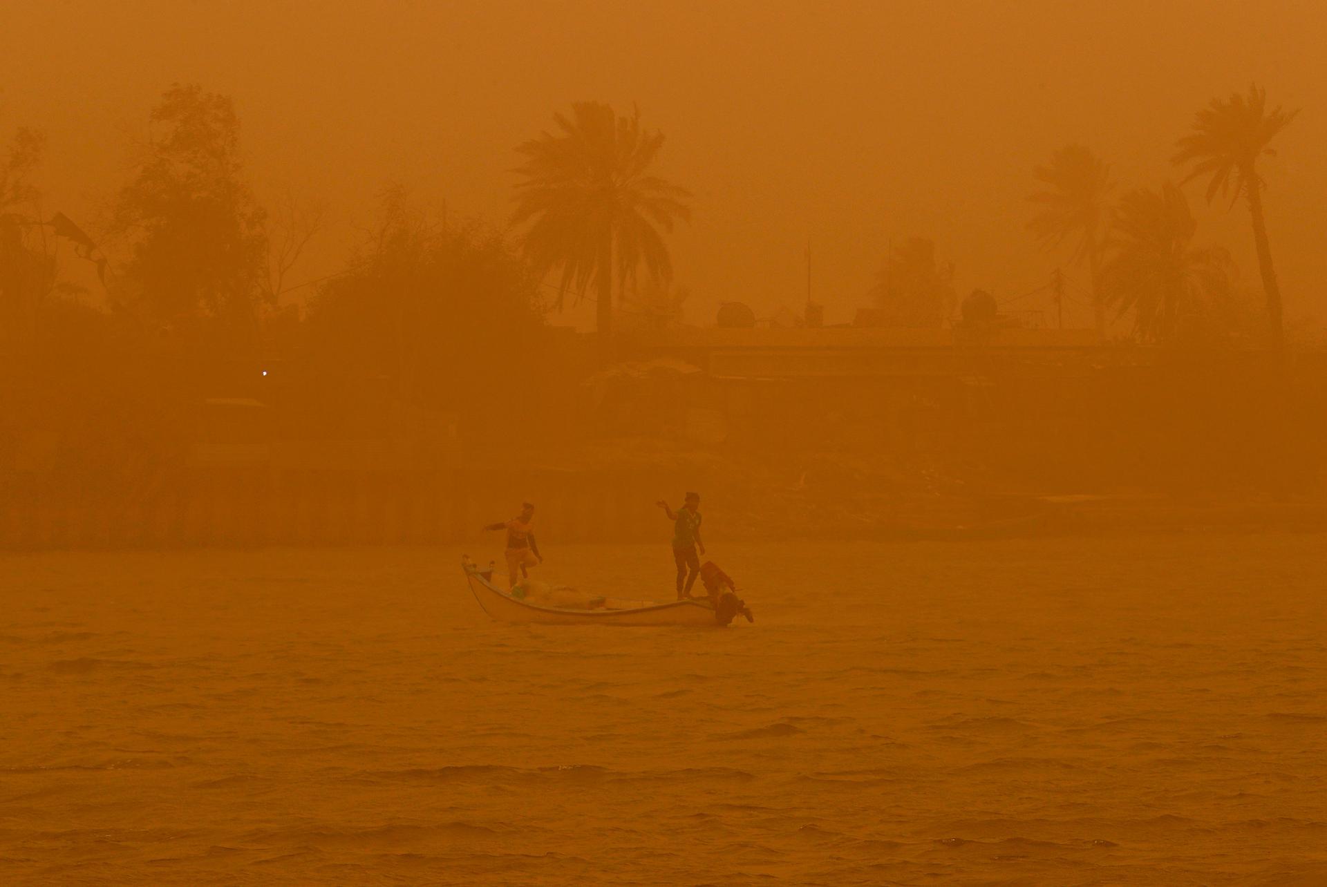 Fishermen navigate on the Shatt al-Arab waterway during a sandstorm in Basra, Iraq, Monday, May 23, 2022.