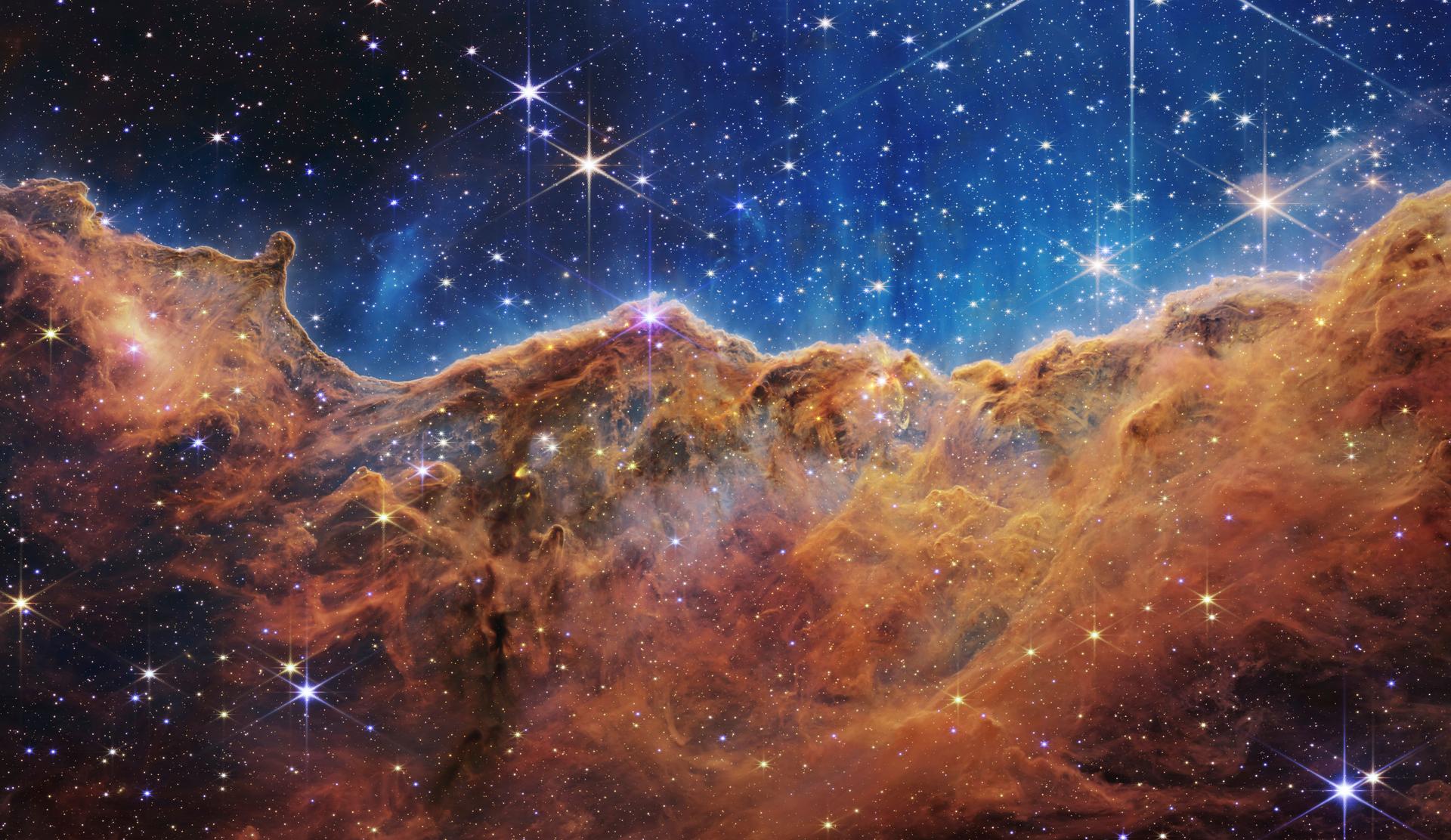 This image shows the edge of a nearby, young, star-forming region NGC 3324 in the Carina Nebula