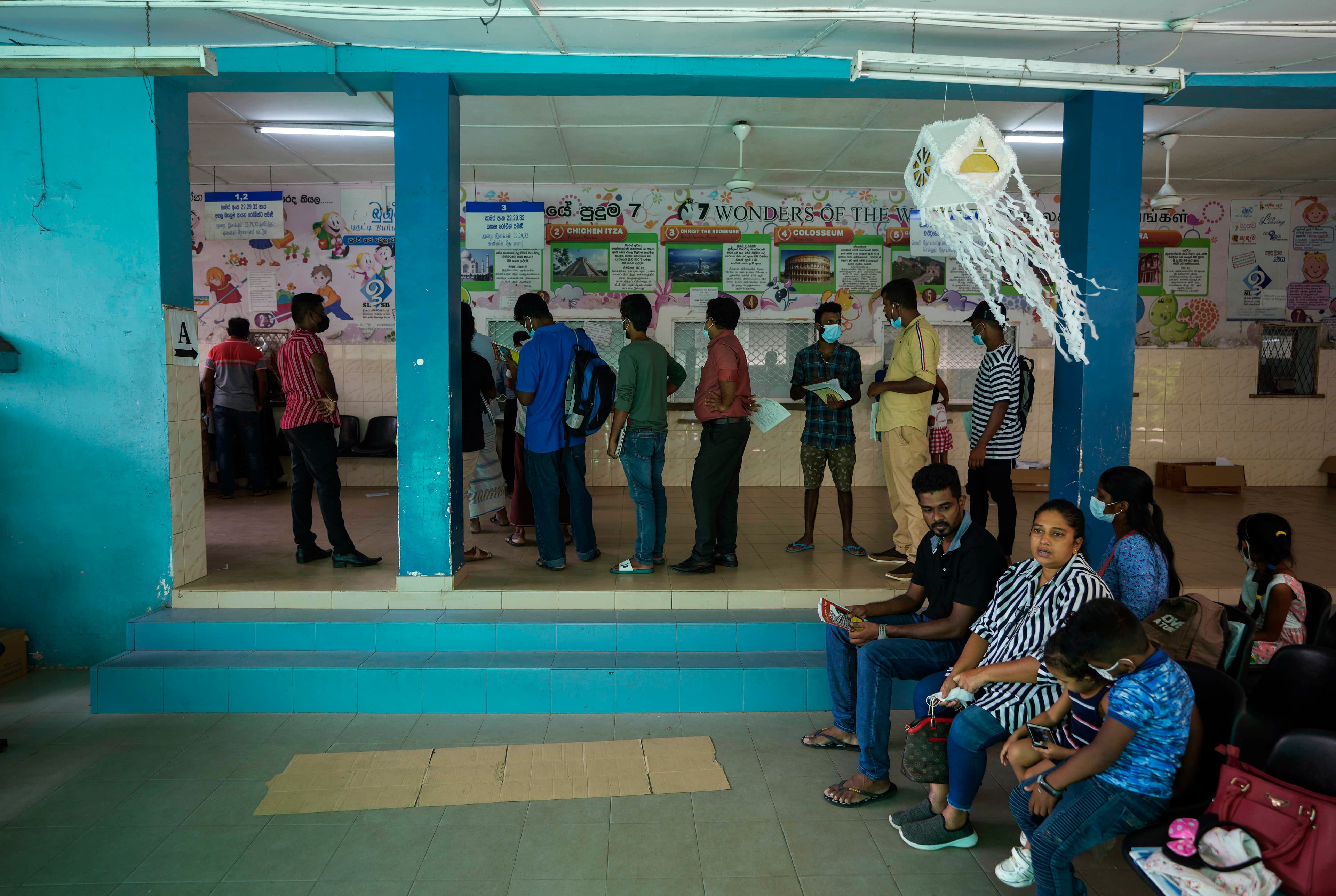 People wait to receive medicine at a pharmacy in a government hospital for children in Colombo, Sri Lanka