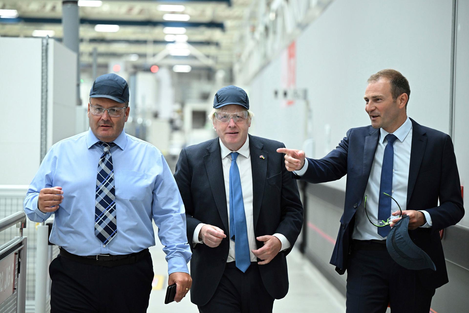 three men in a hallway